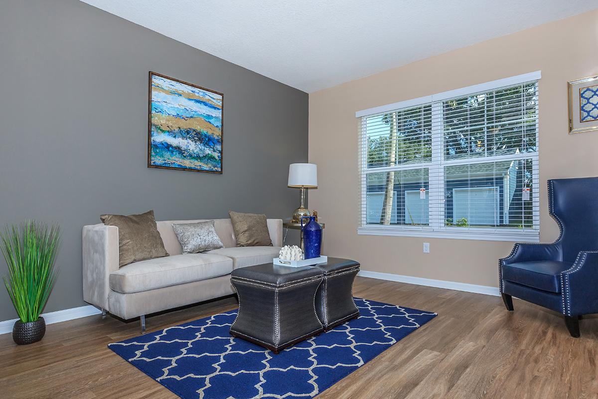 a living room filled with furniture and a large window