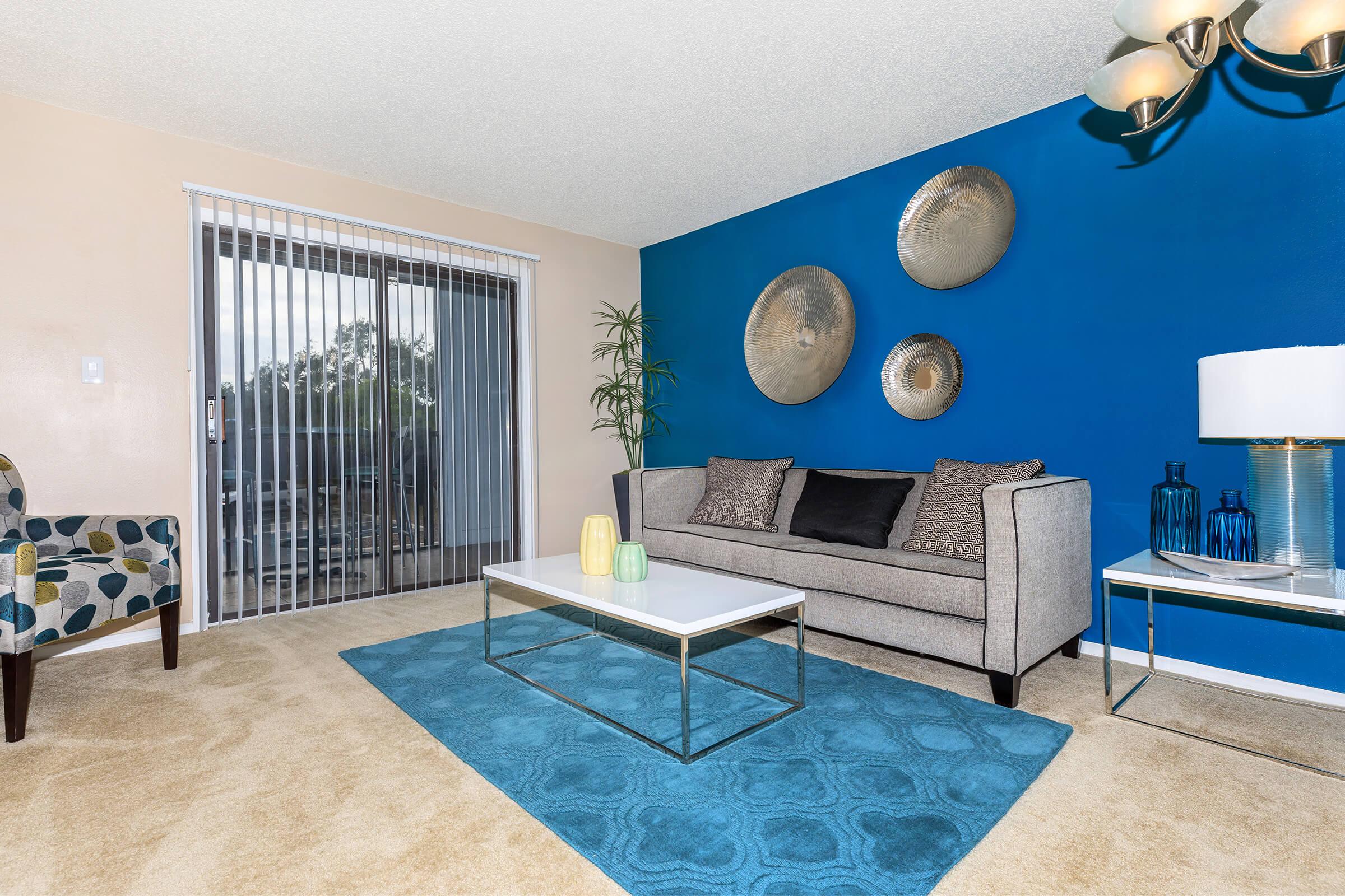 a living room filled with furniture and a blue chair