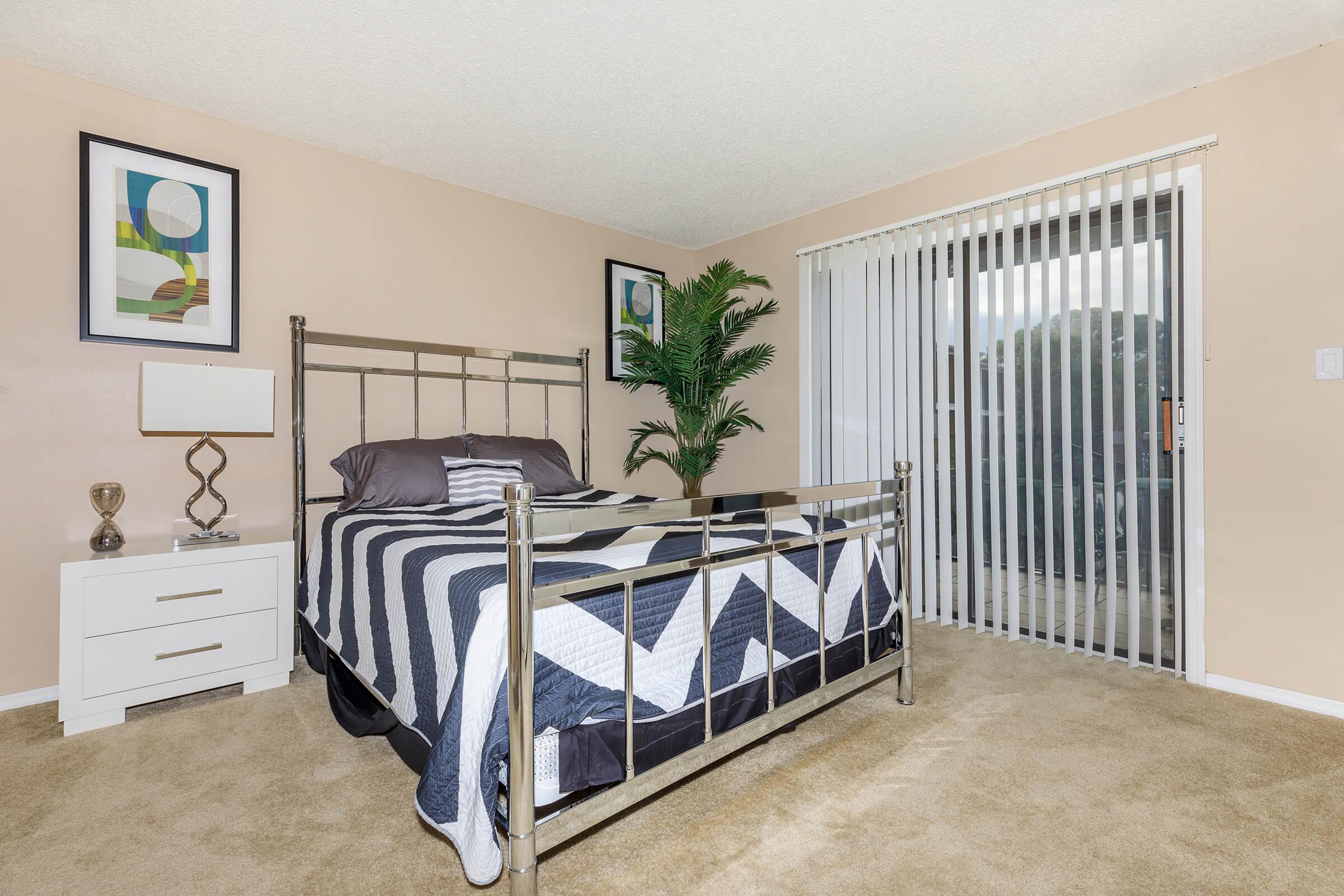 a bedroom with a bed and desk in a room