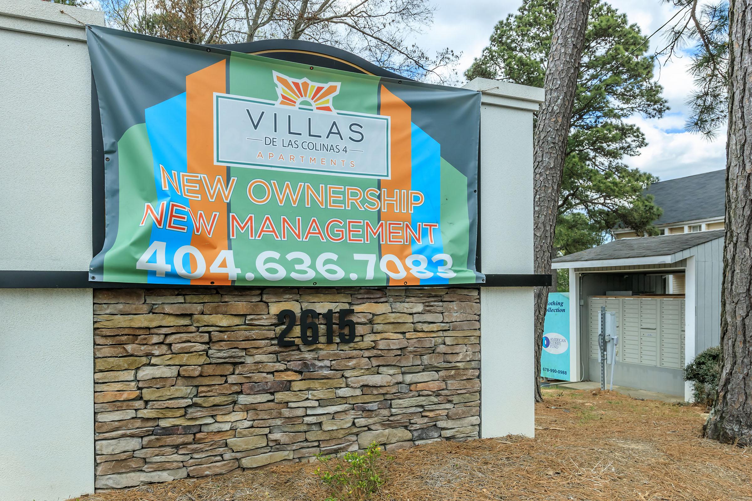 a sign in front of a brick building