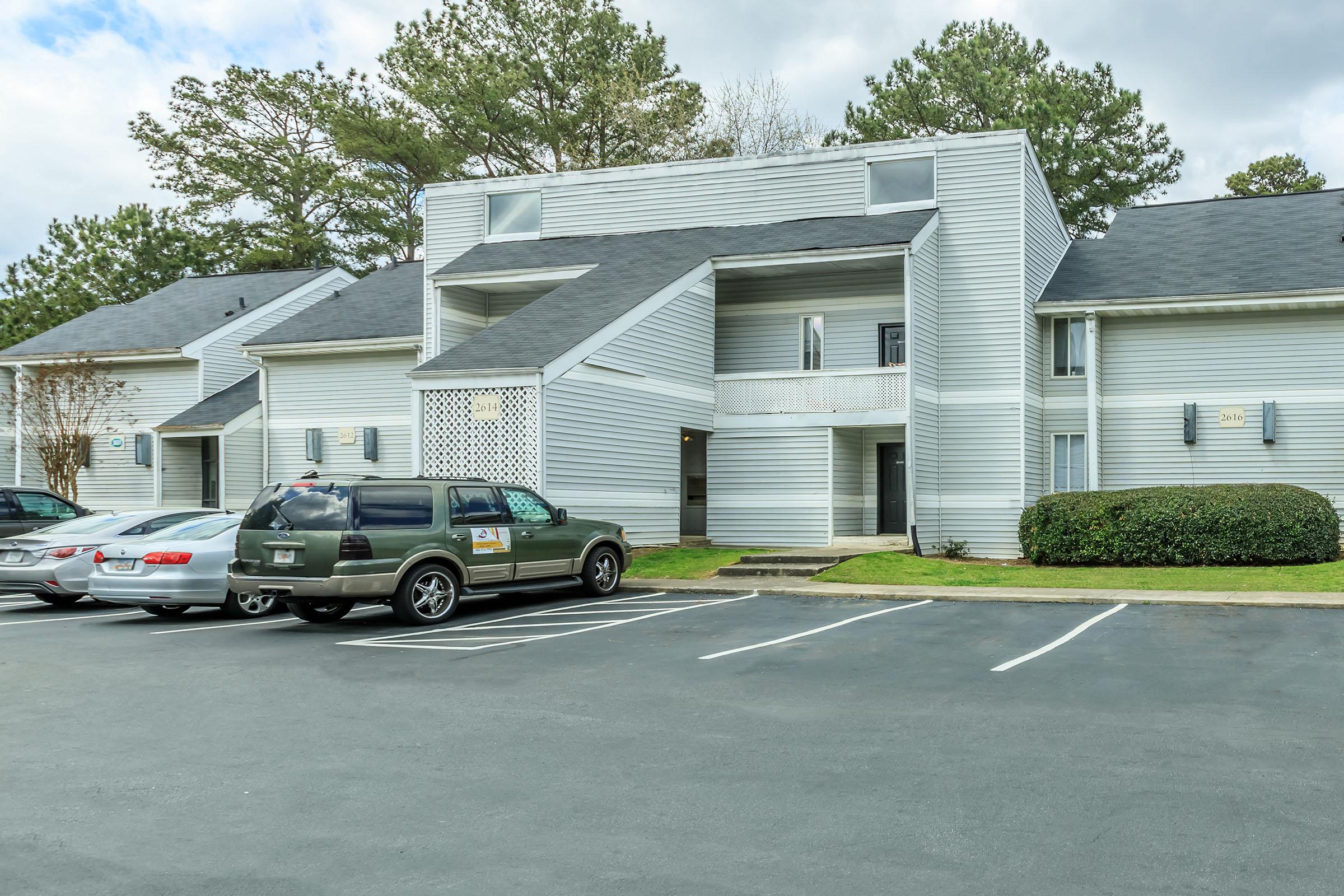 a car parked in a parking lot in front of a house