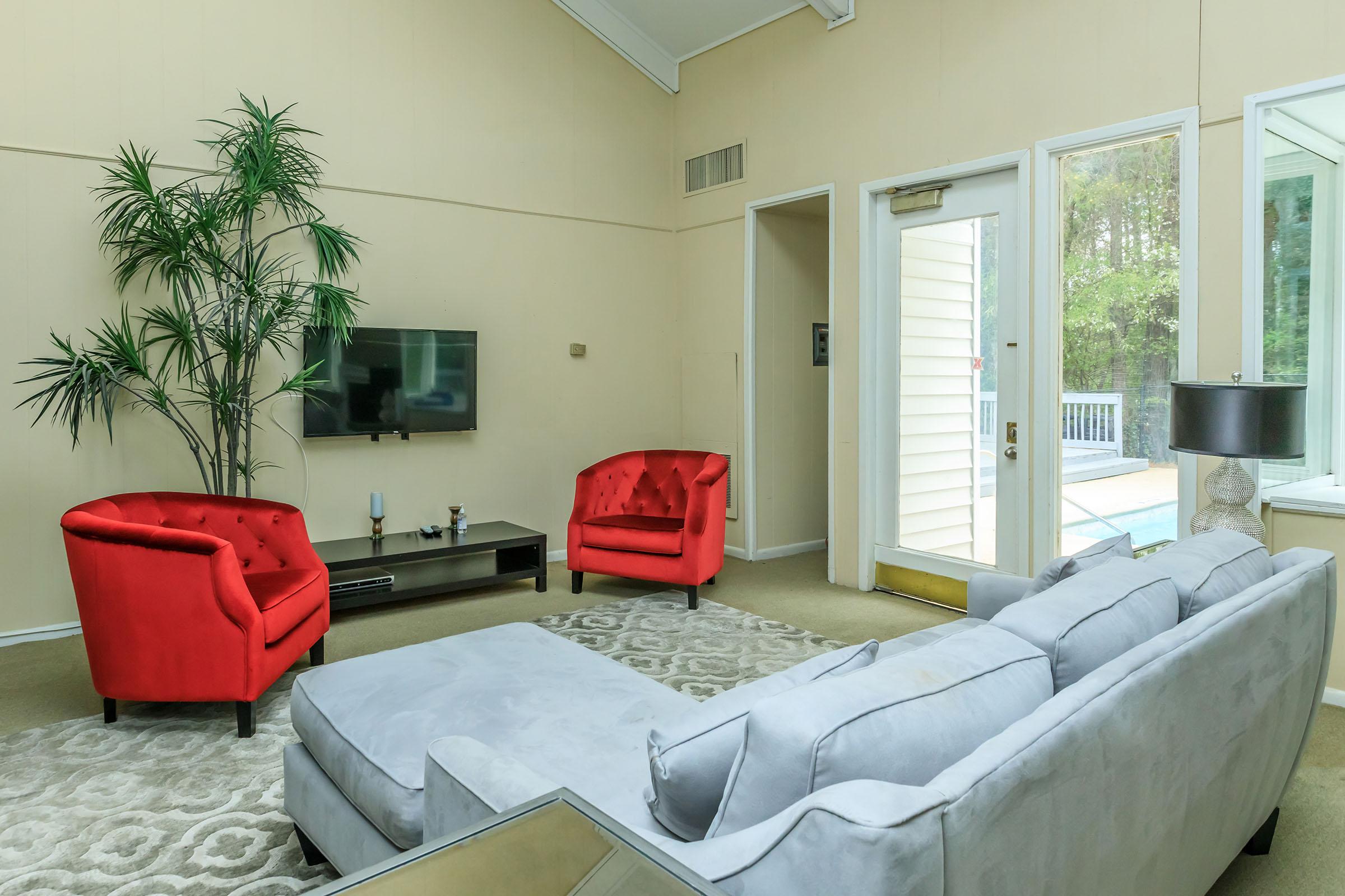 a living room filled with furniture and a large window