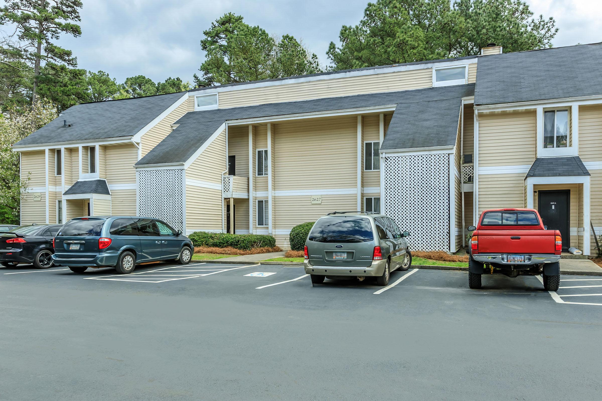 a car parked in a parking lot in front of a house