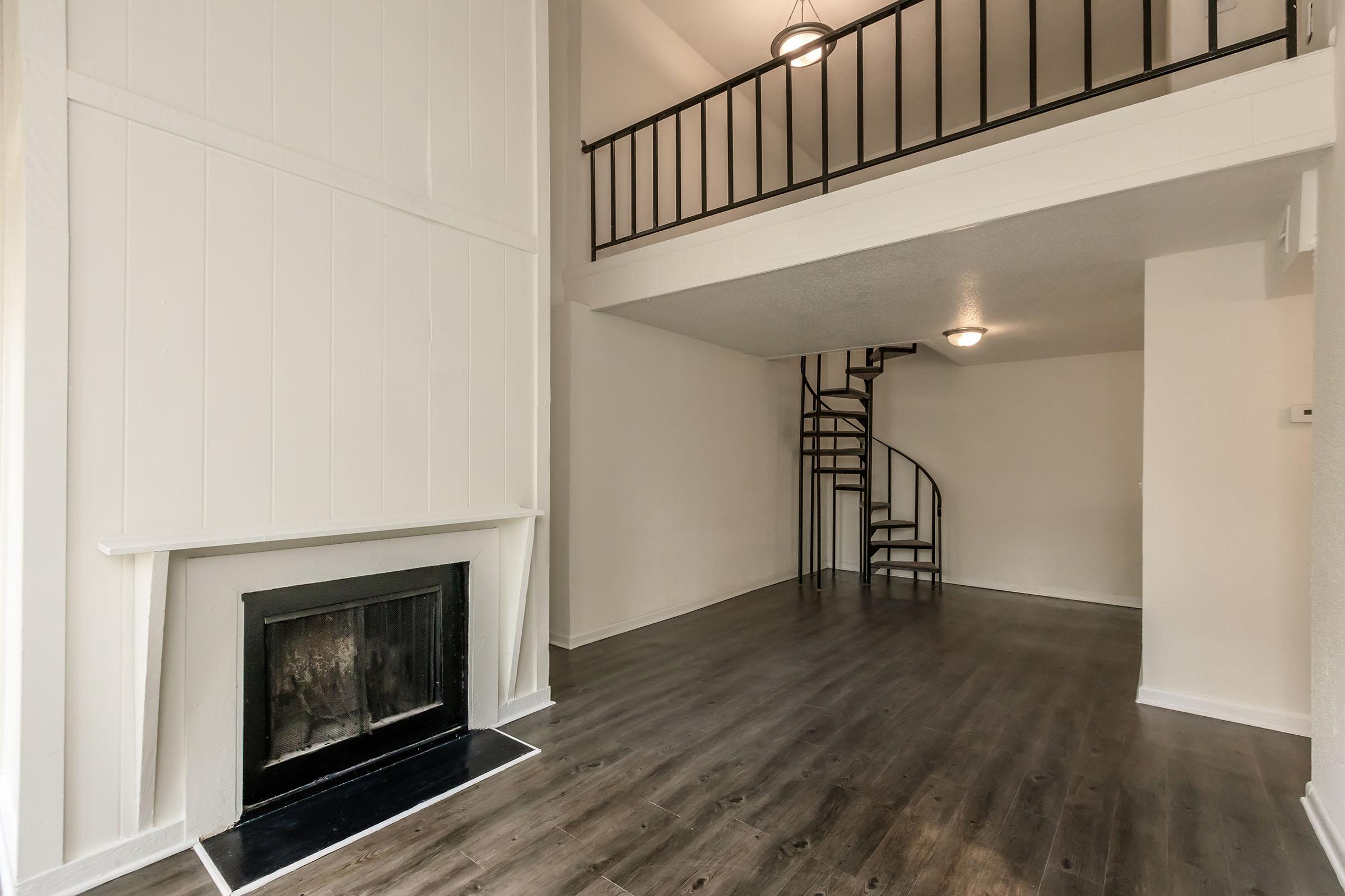 a room with a fireplace and a large window