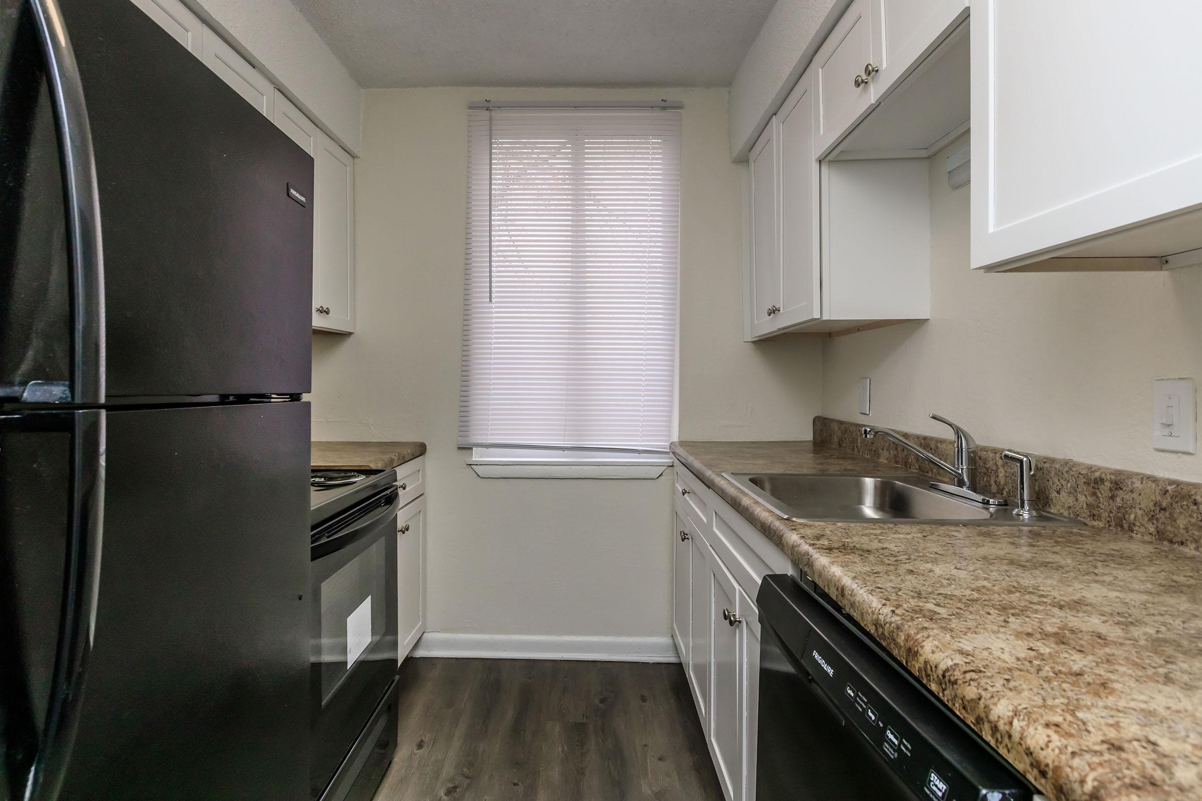 a kitchen with a sink and a window