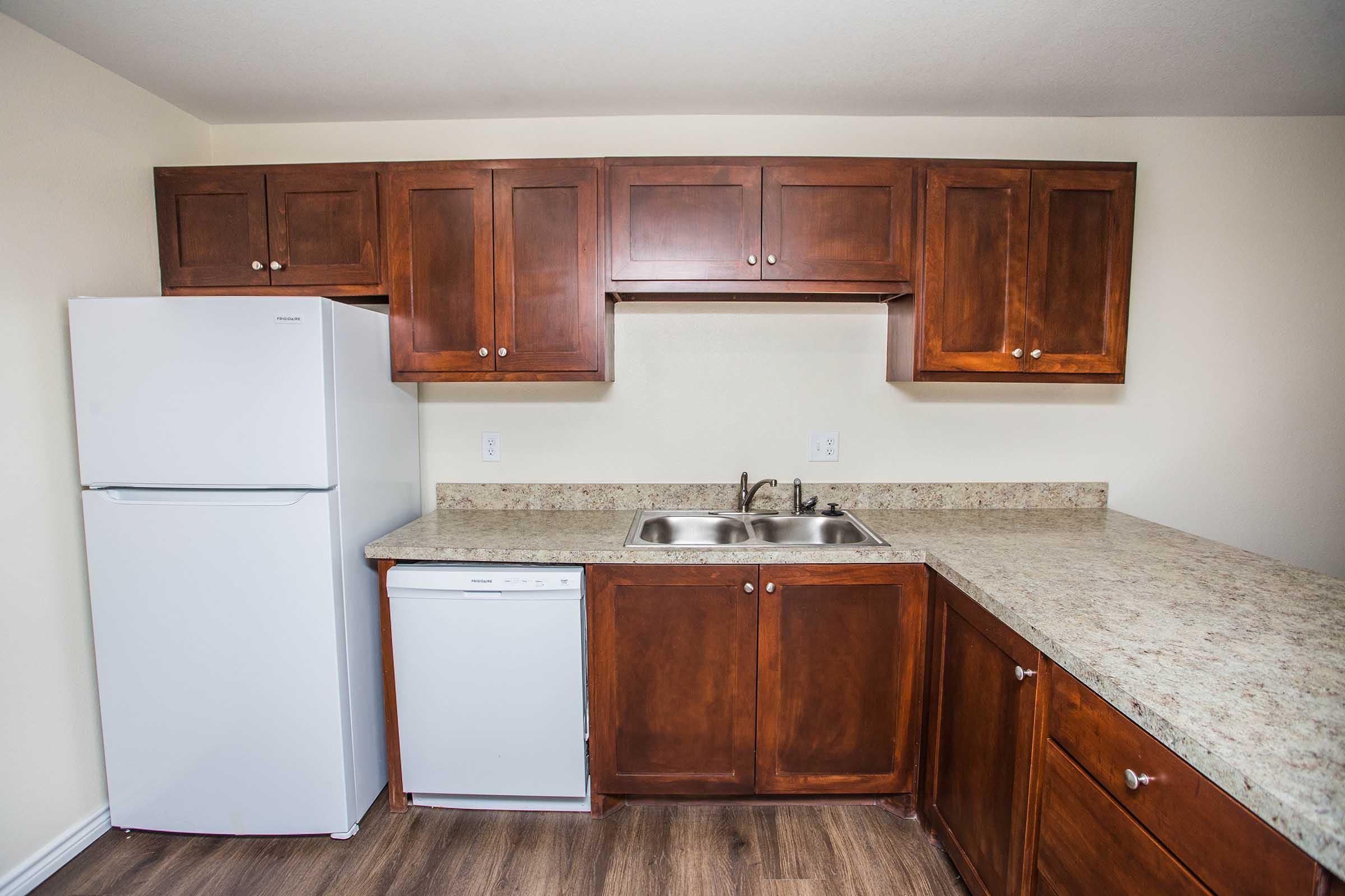 a kitchen with stainless steel appliances and wooden cabinets