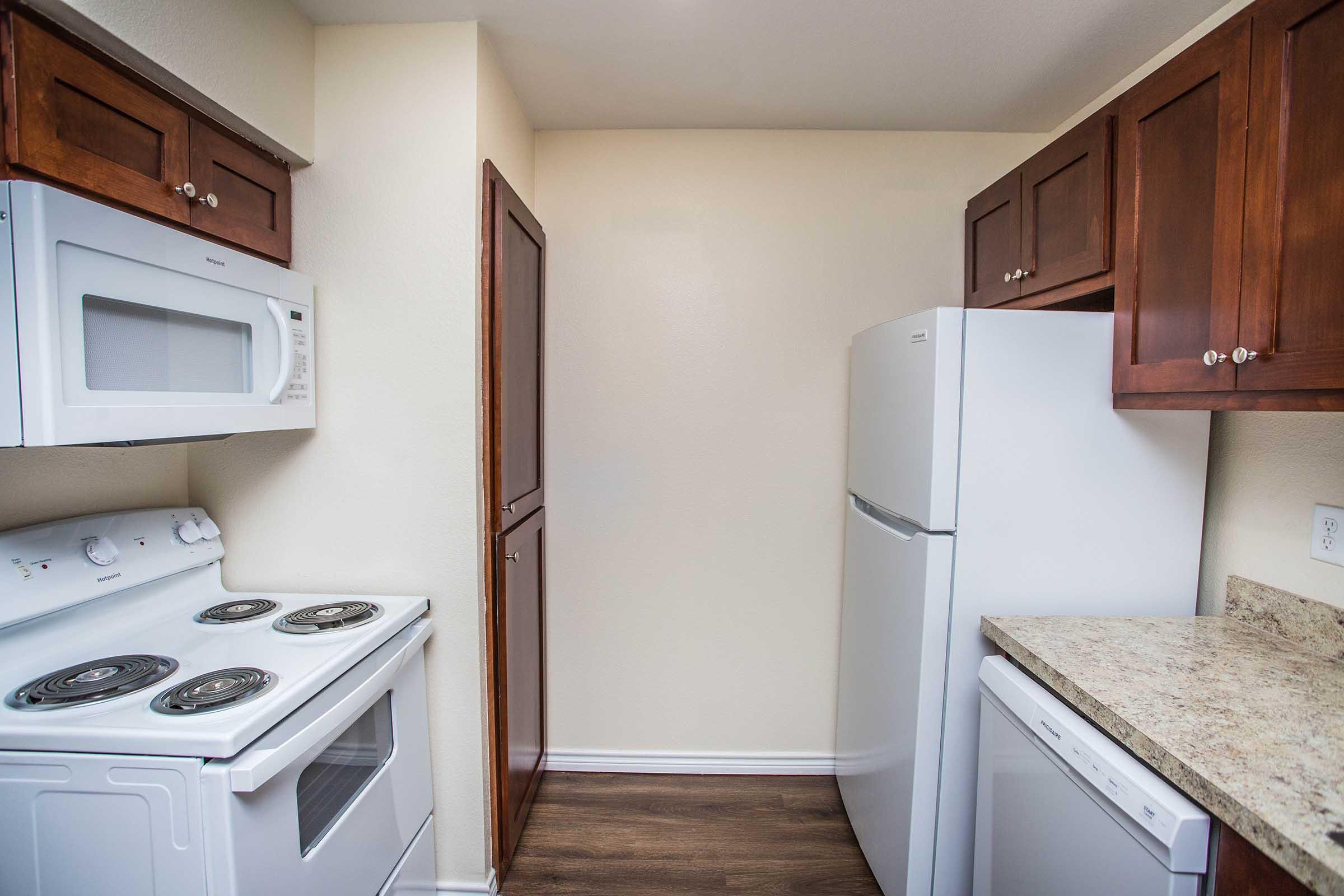 a kitchen with a stove top oven sitting inside of a refrigerator