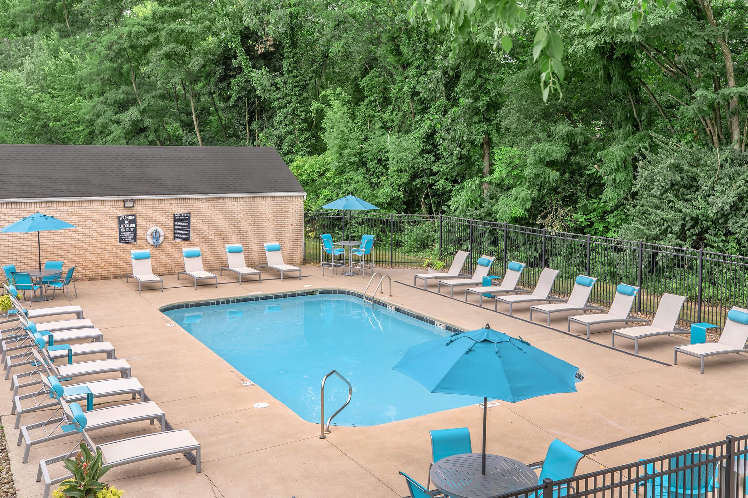 a group of lawn chairs sitting next to a pool