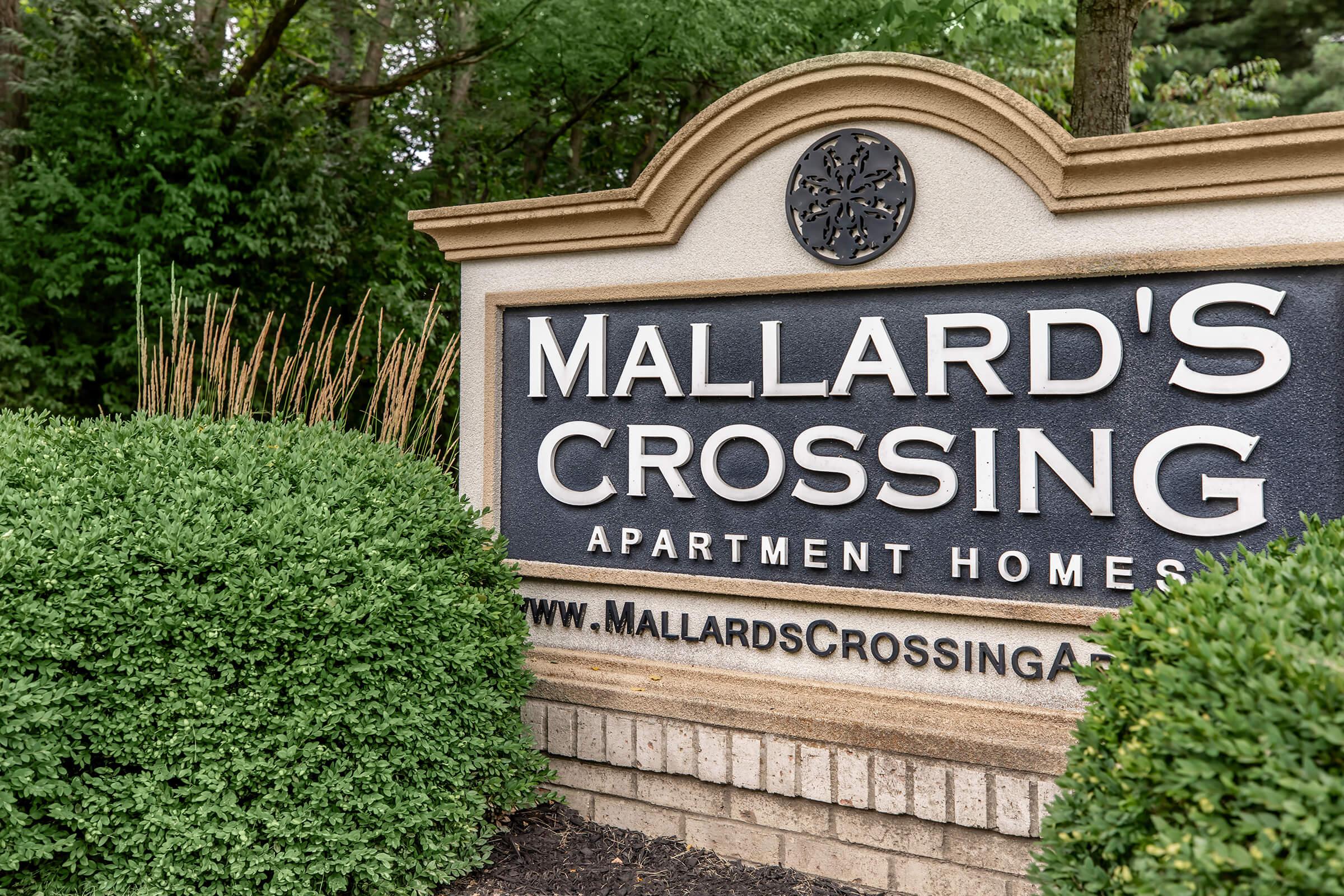 a sign in front of a brick building