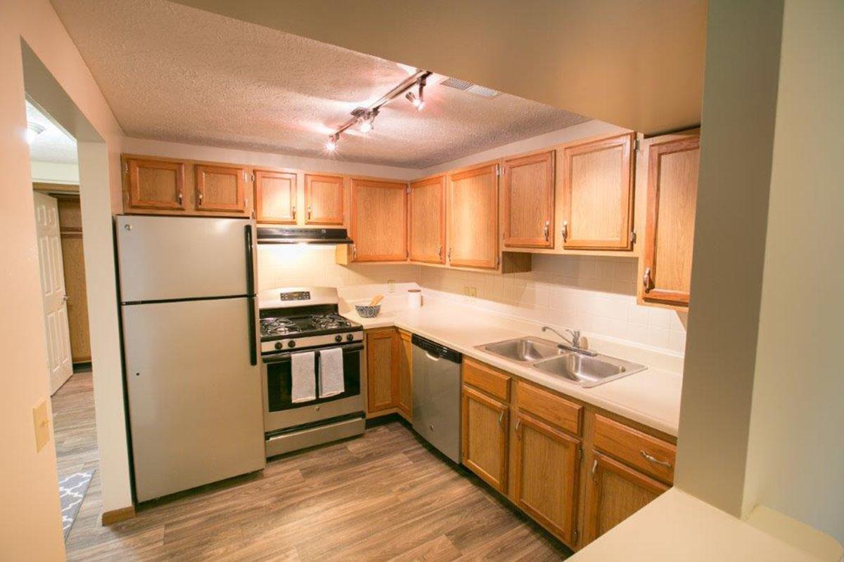 a kitchen with stainless steel appliances and wooden cabinets