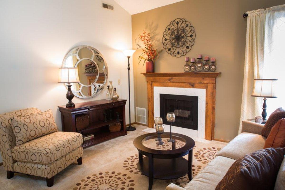 a living room filled with furniture and a fire place