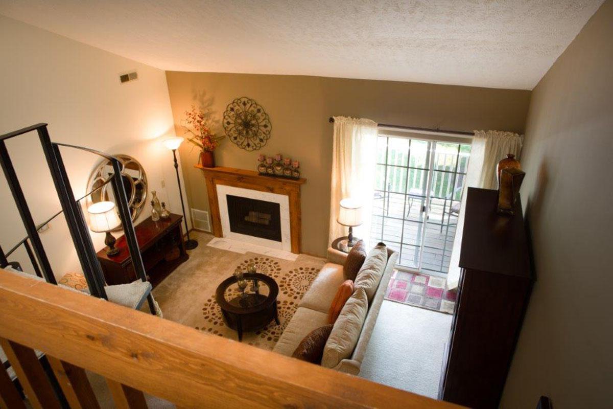 a view of a living room filled with furniture and a fireplace
