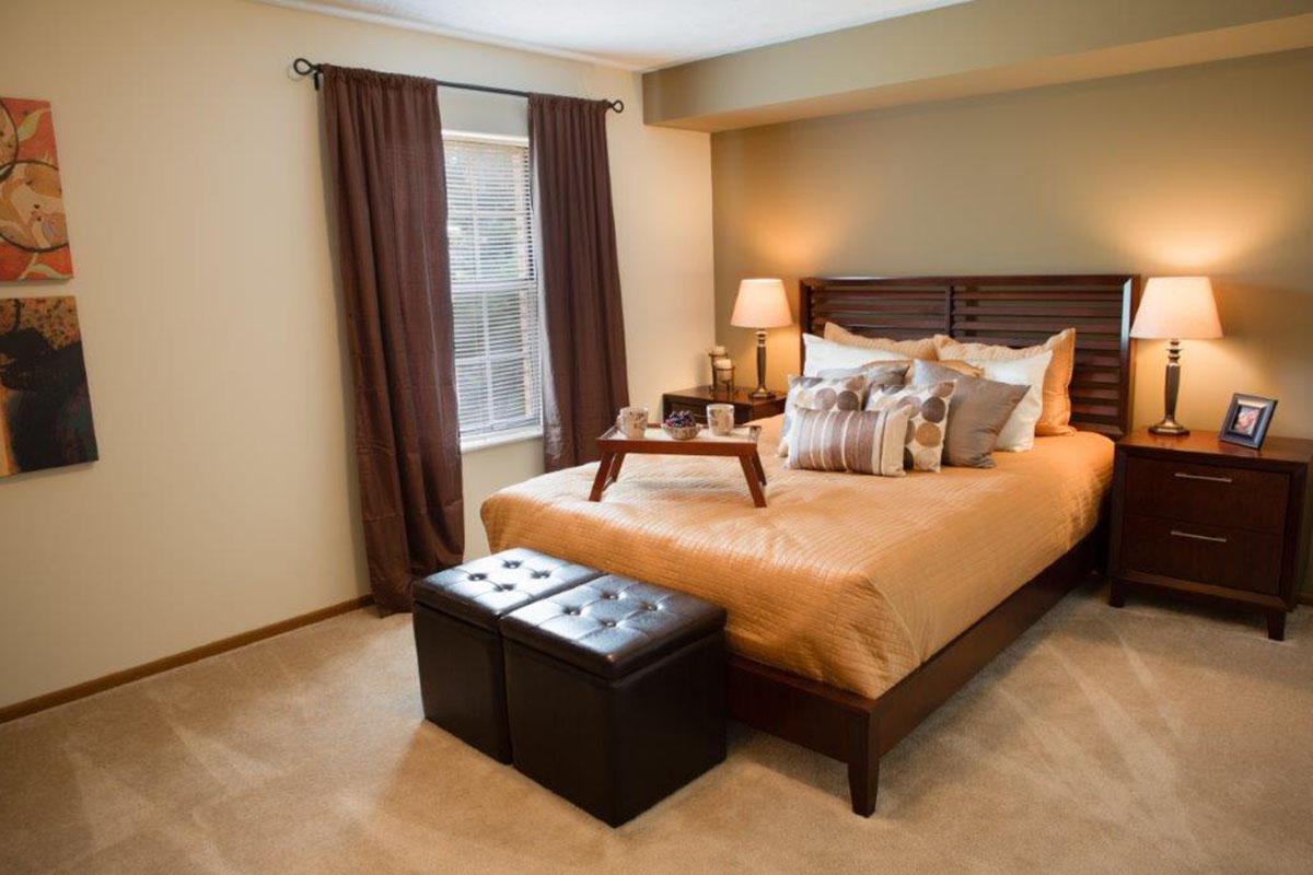 a bedroom with a bed and desk in a room