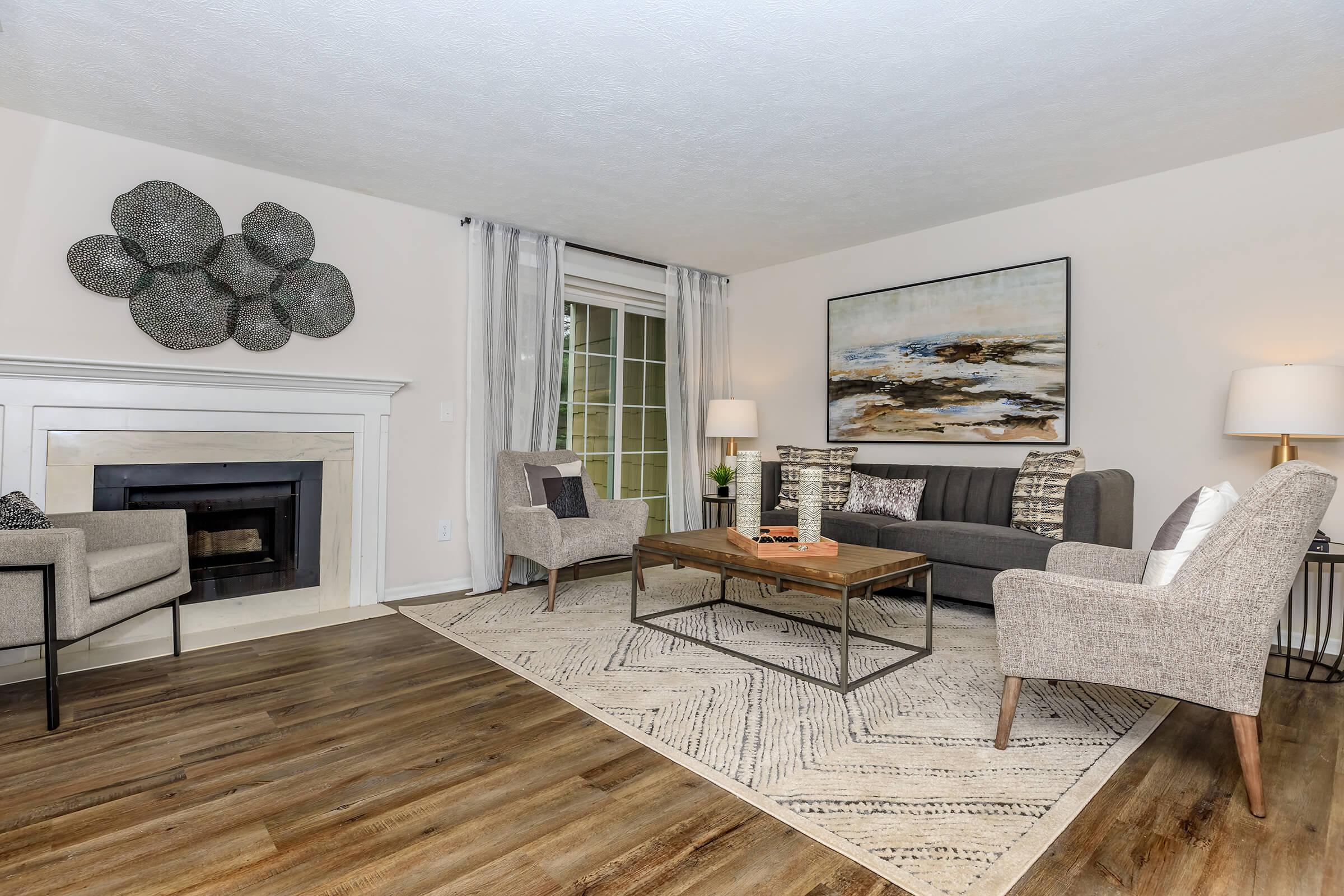 a living room filled with furniture and a fireplace