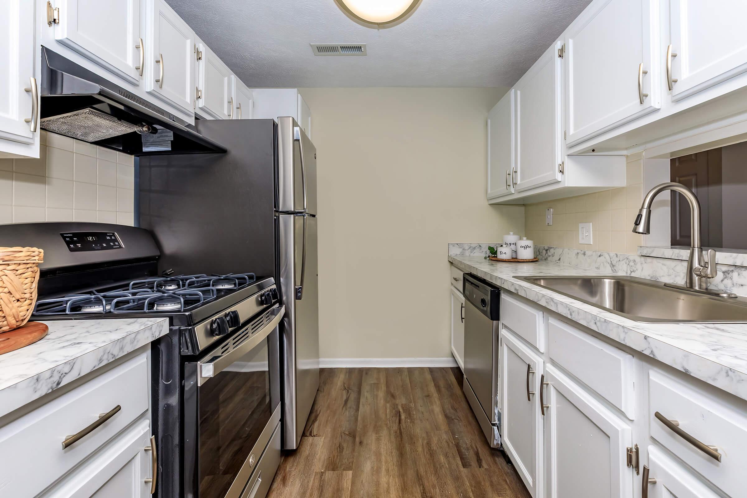 a kitchen with a stove a sink and a microwave