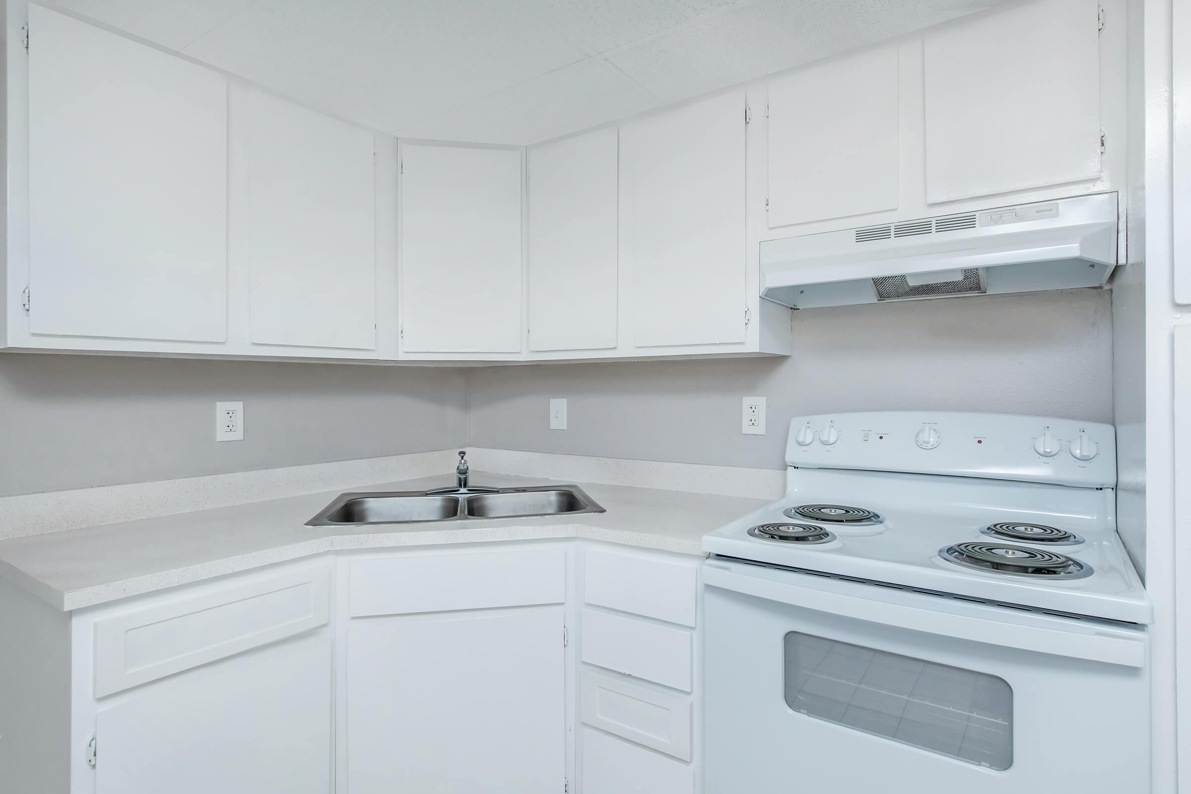 a stove top oven sitting inside of a kitchen