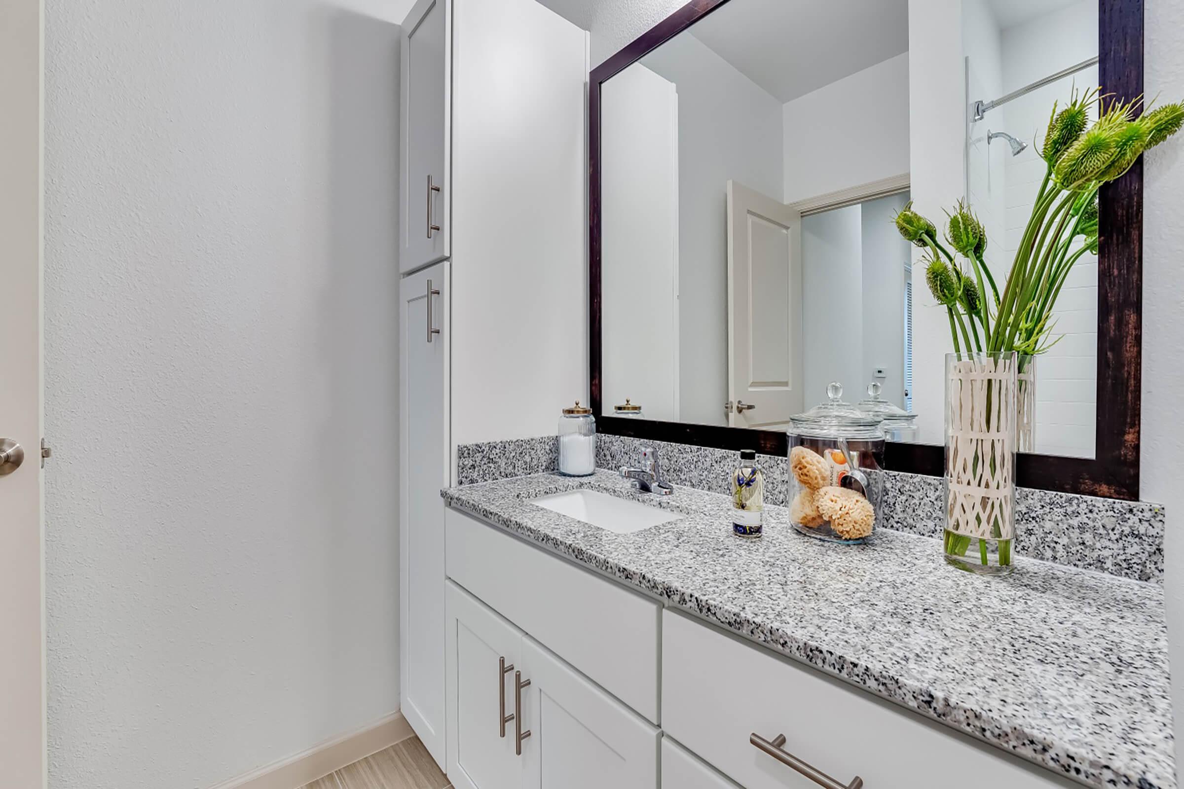 a kitchen with a sink and a mirror