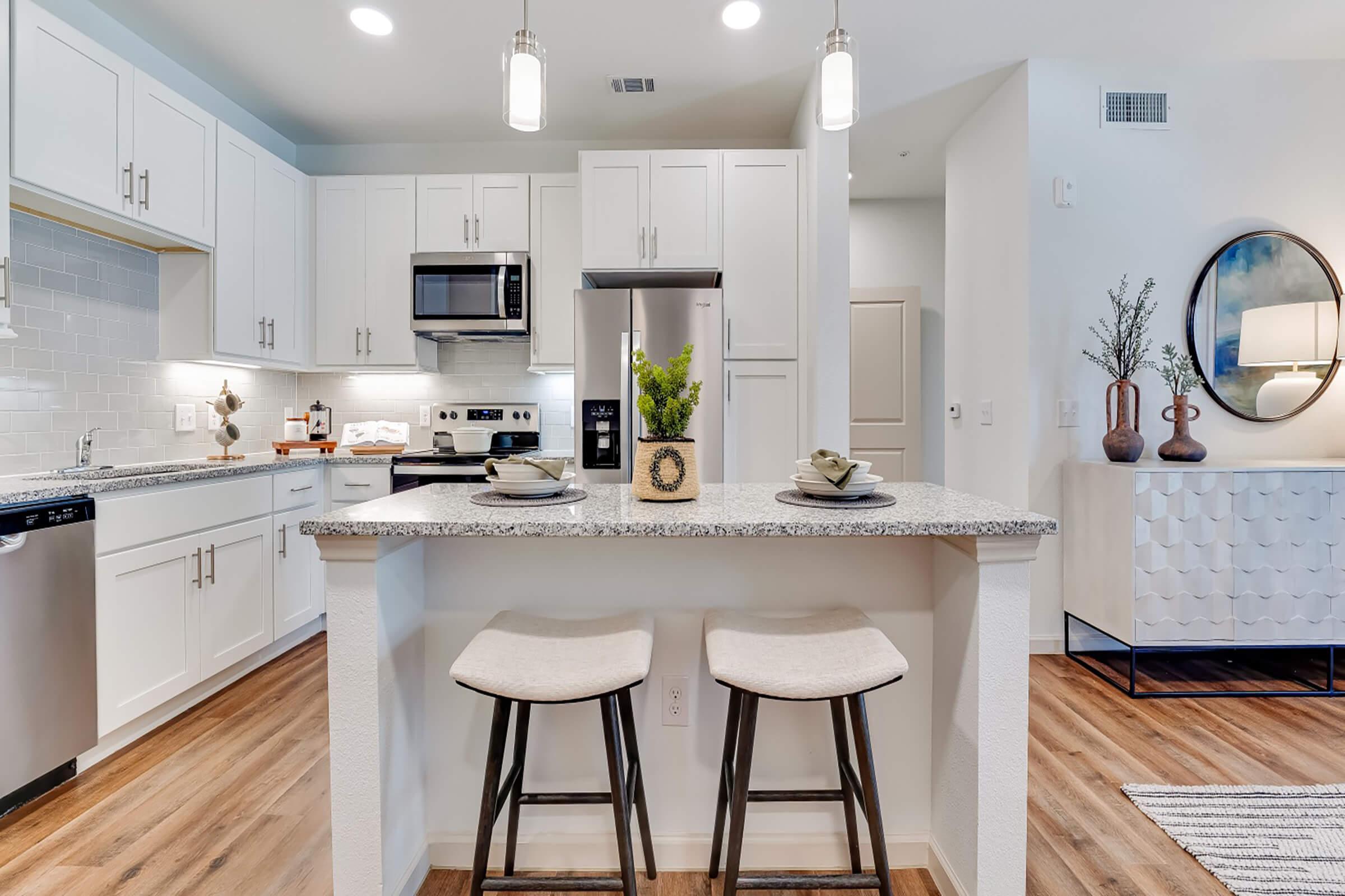 a kitchen with an island in the middle of a room