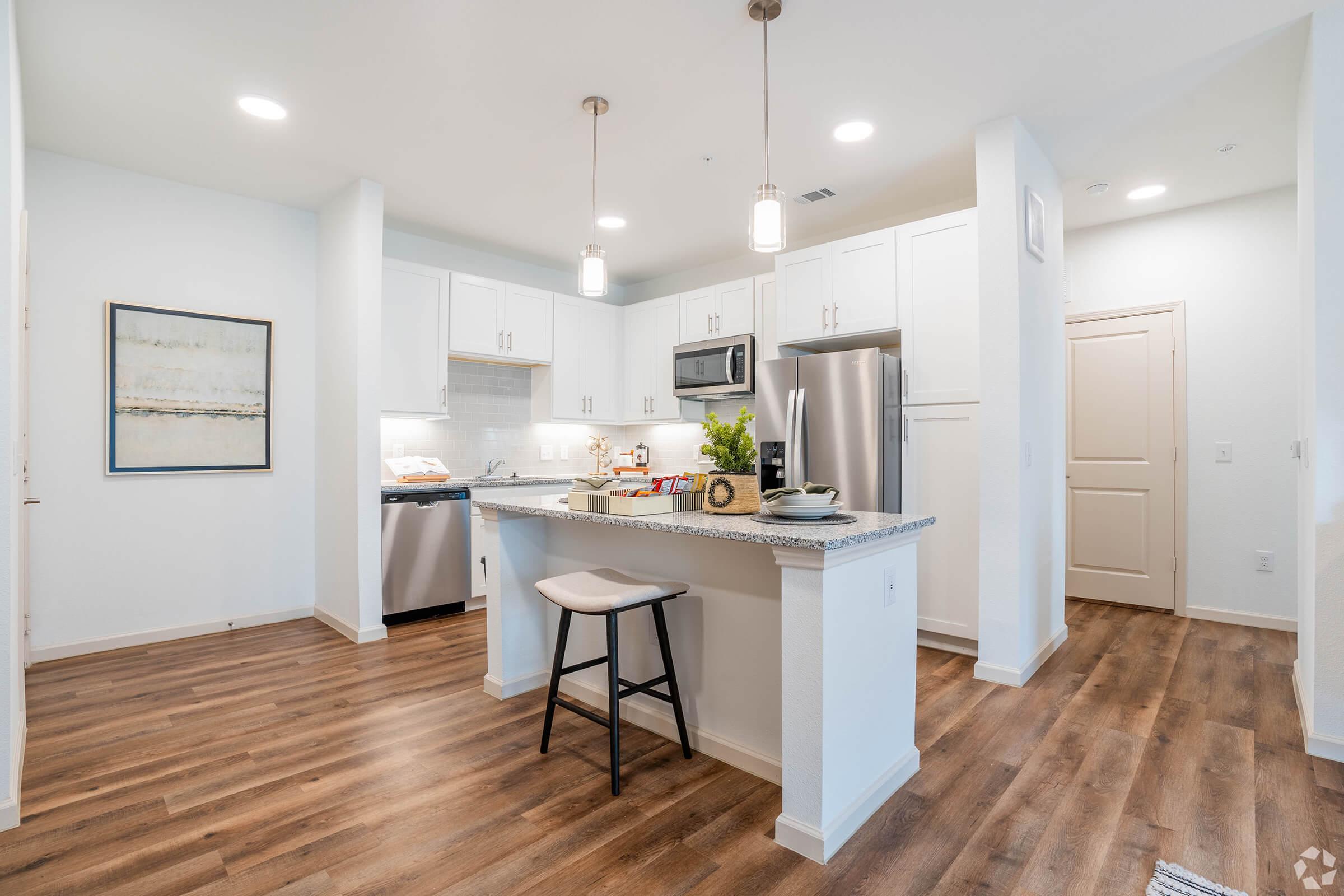 a kitchen with a wood floor in a room