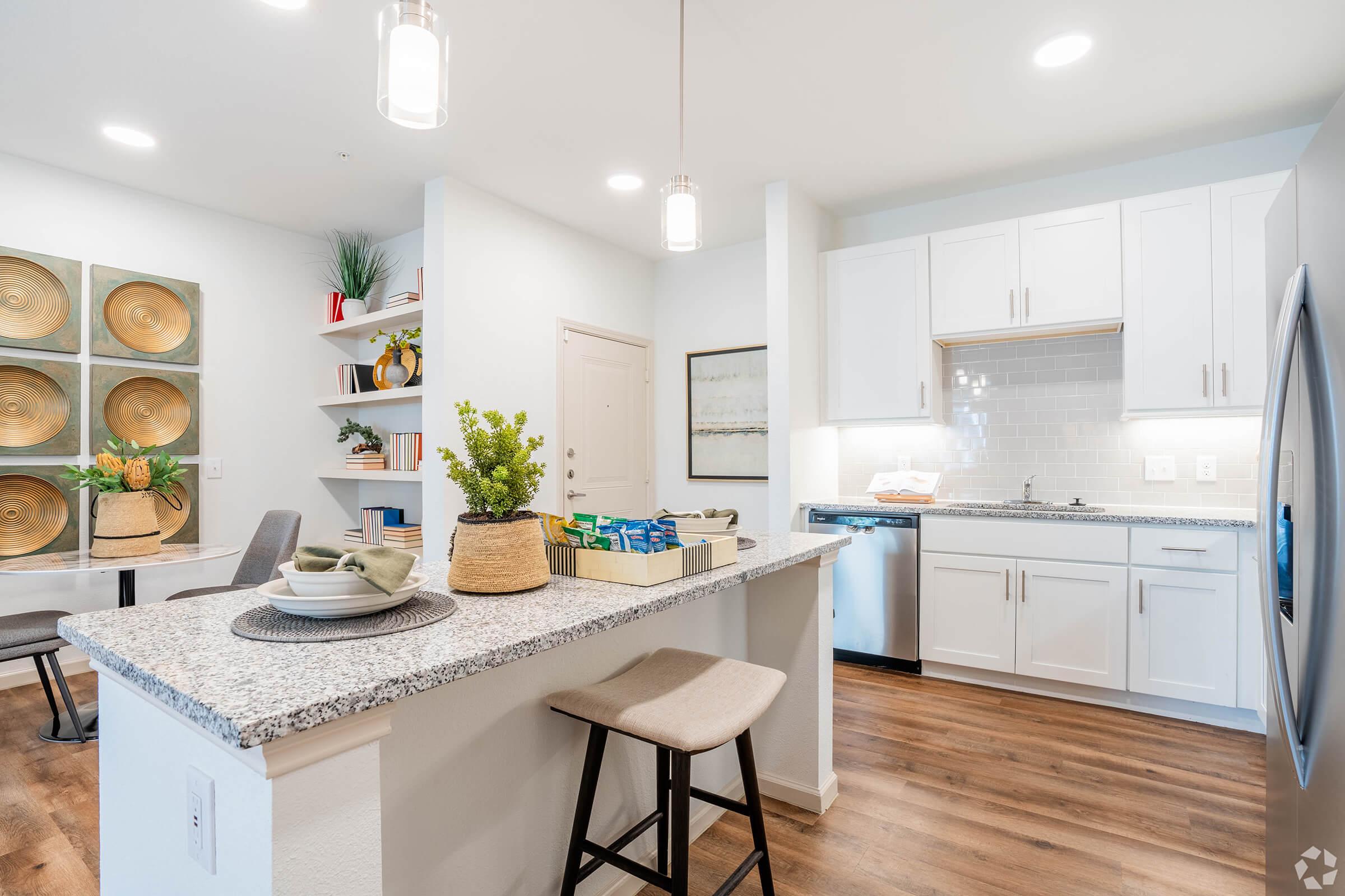 a kitchen with an island in the middle of a table