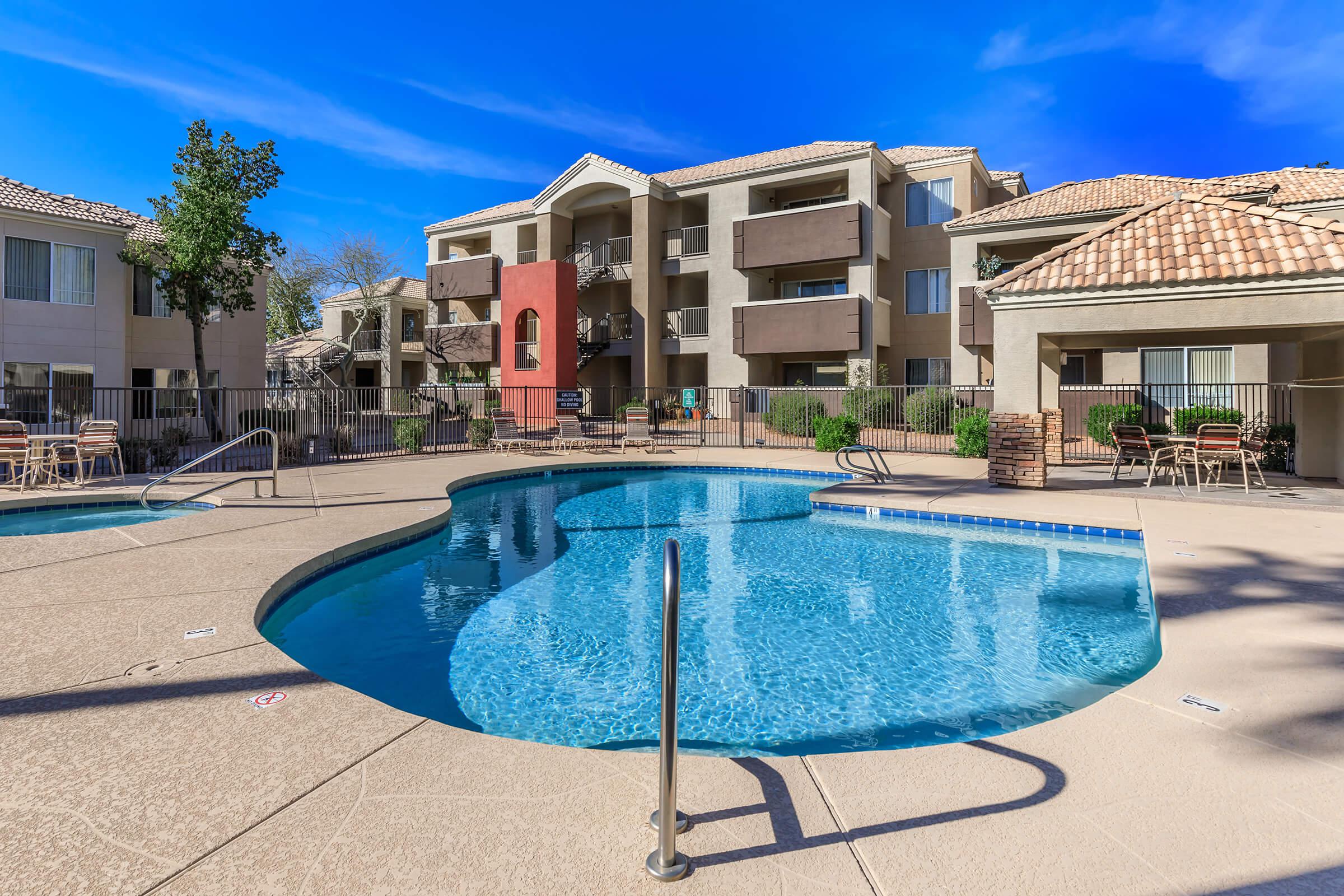 a house with a pool in front of a building
