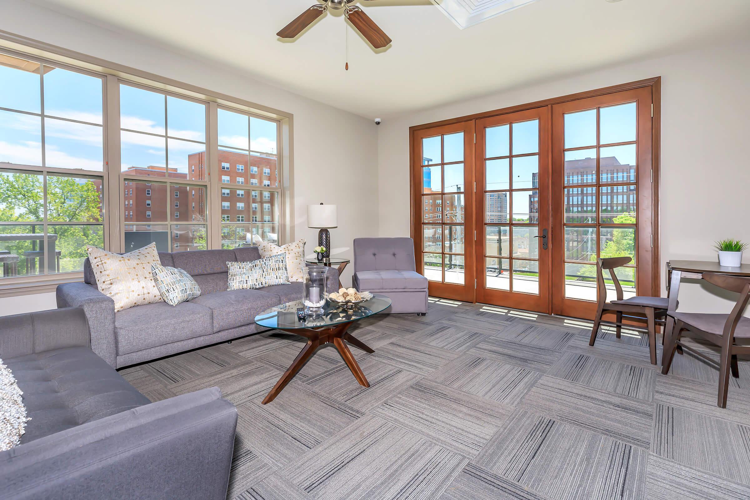 a living room filled with furniture and a large window