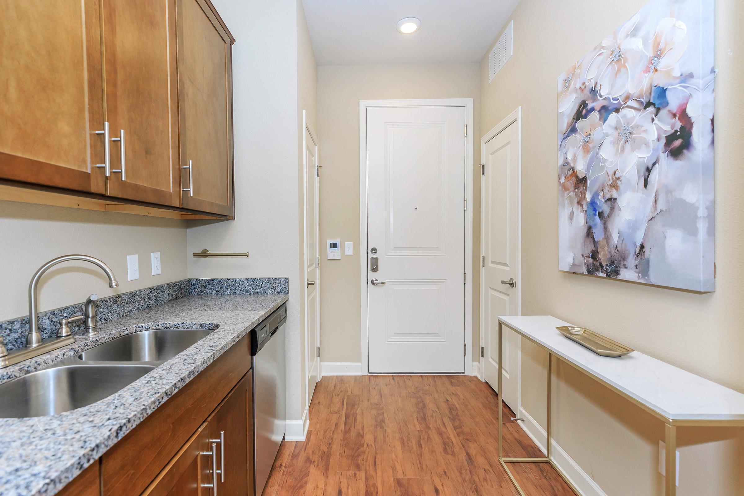 a kitchen with wooden cabinets and a sink