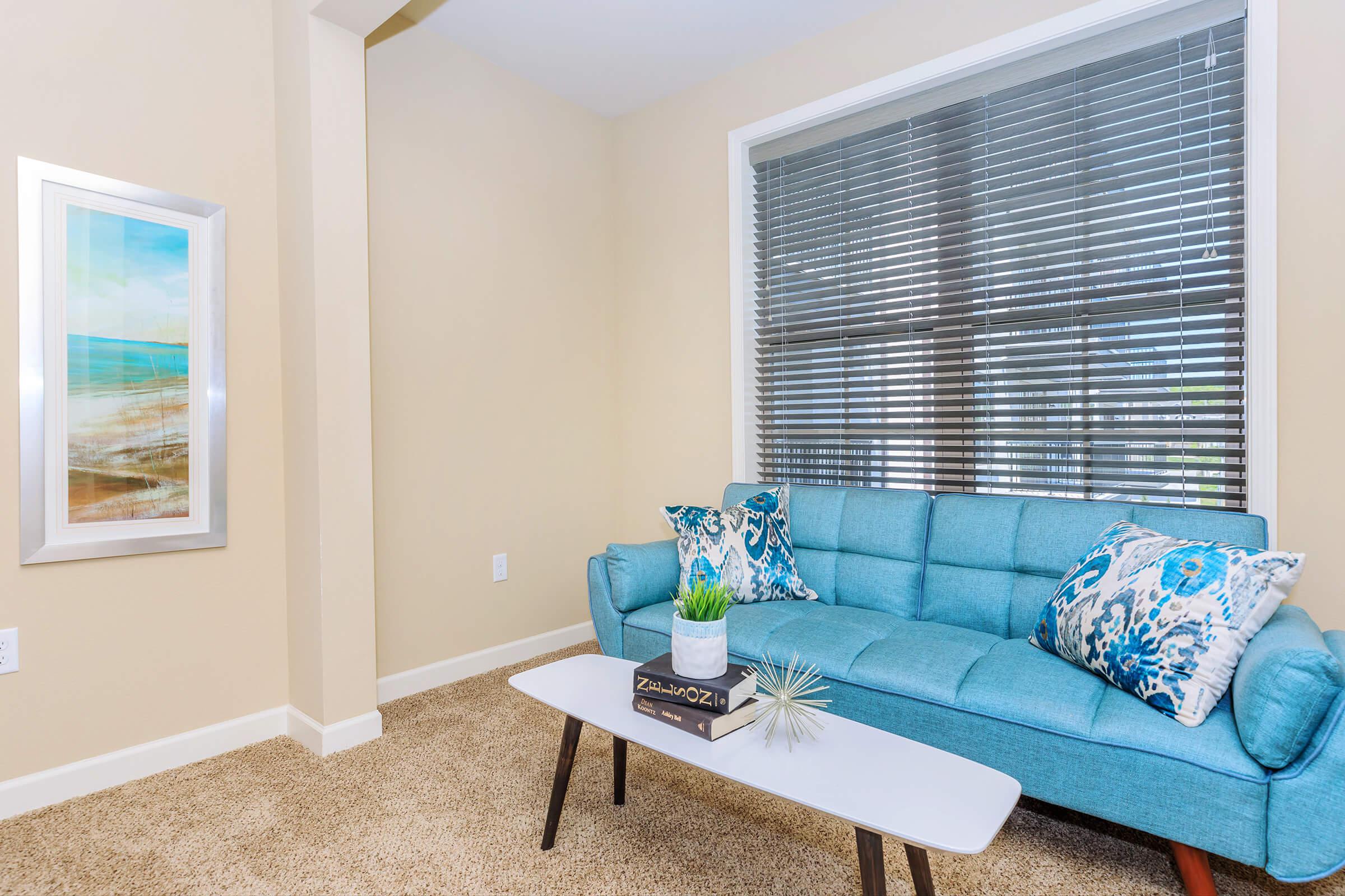 a living room filled with furniture and a large window