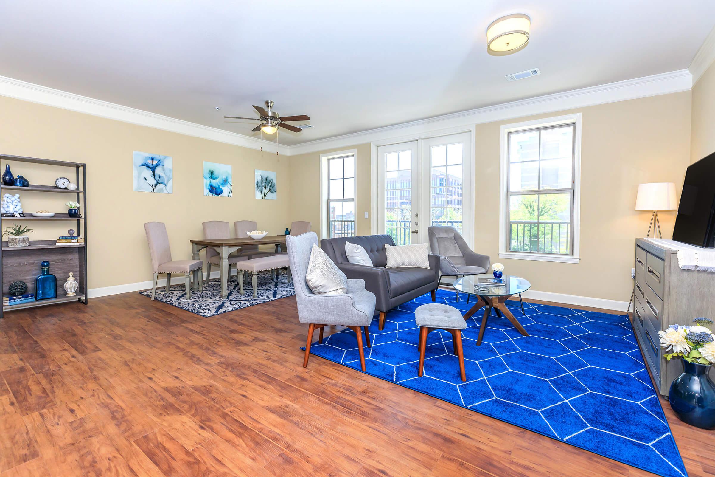 a living room filled with furniture and a wood floor