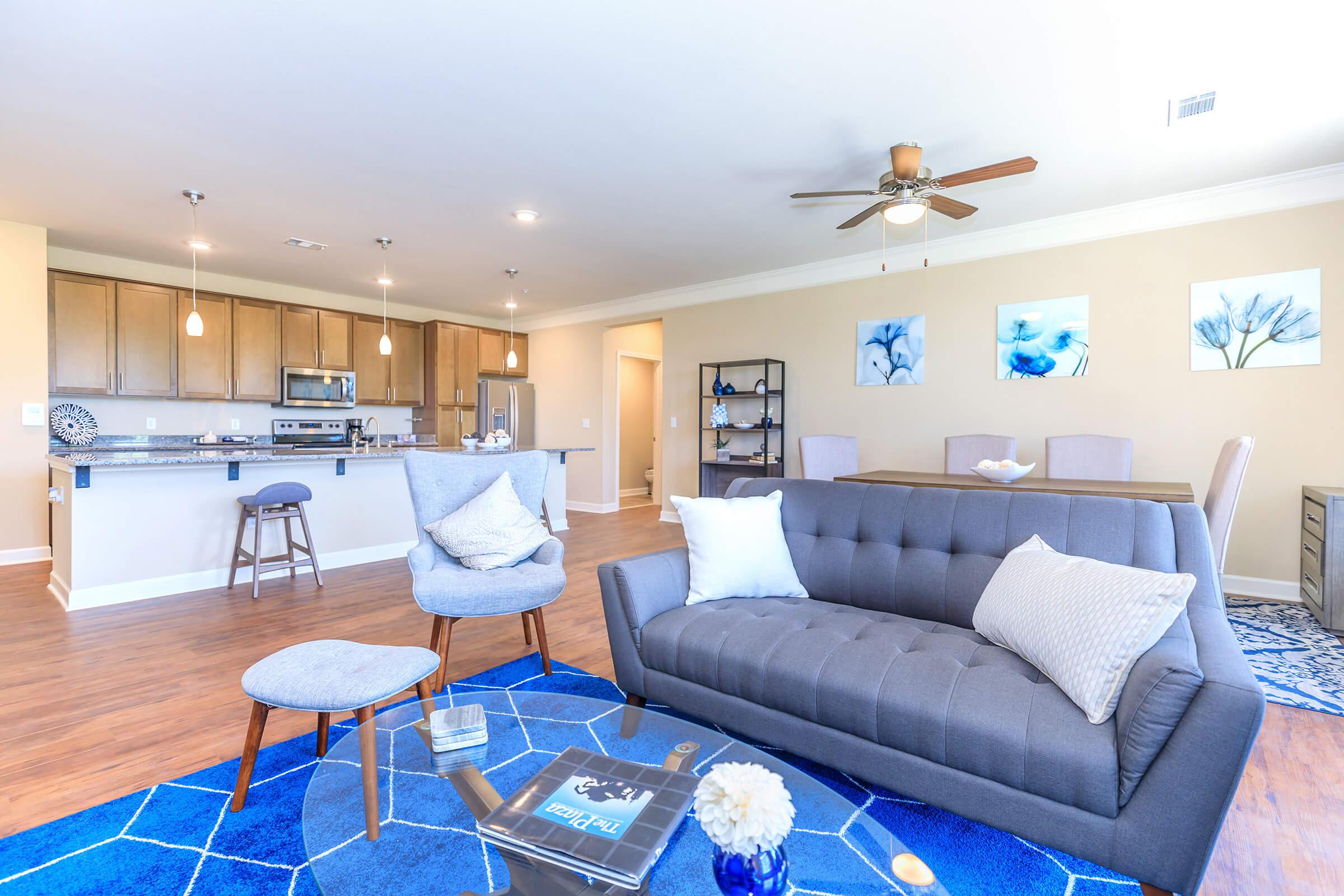 a living room filled with furniture and a blue chair