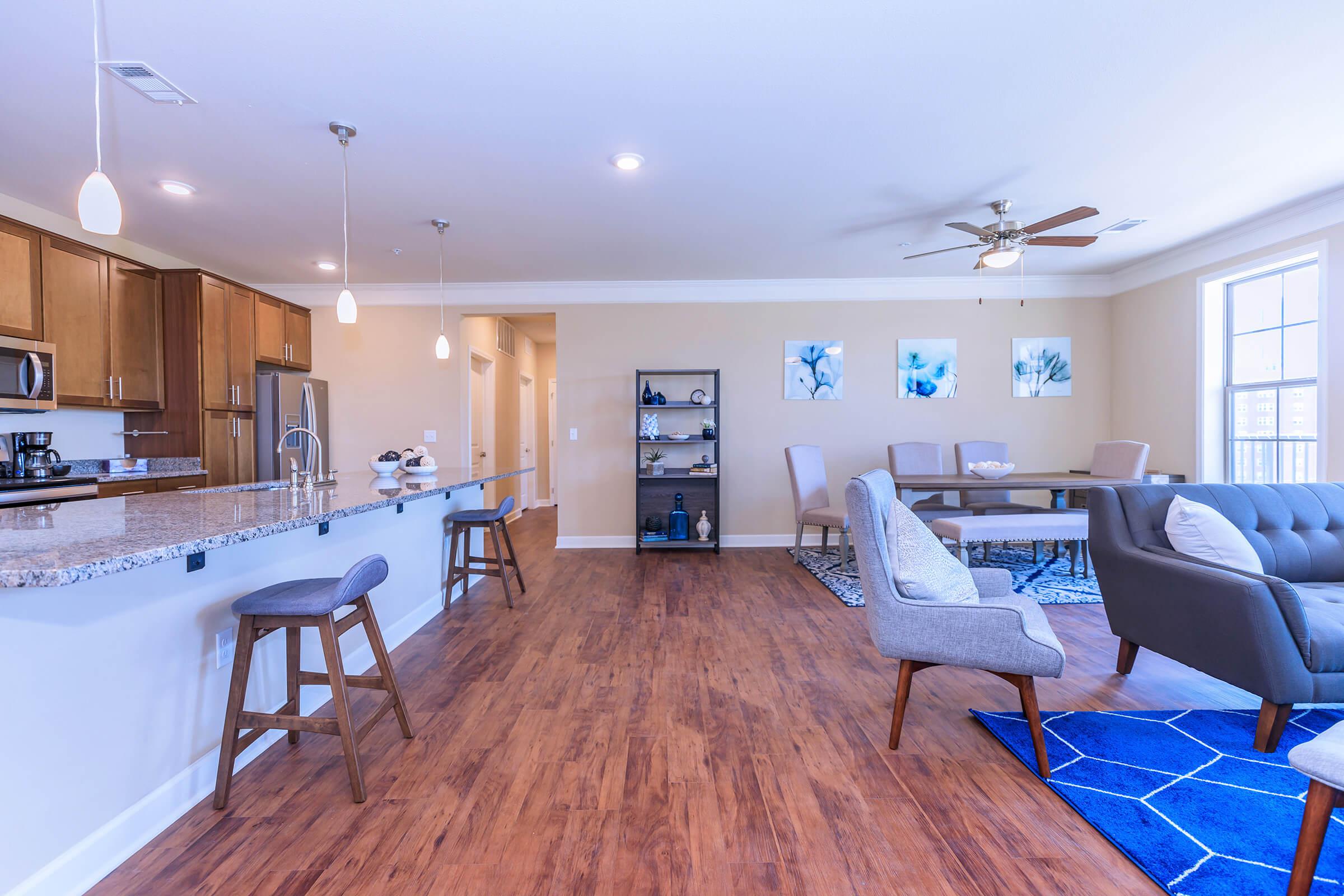 a living room filled with furniture and a wood floor