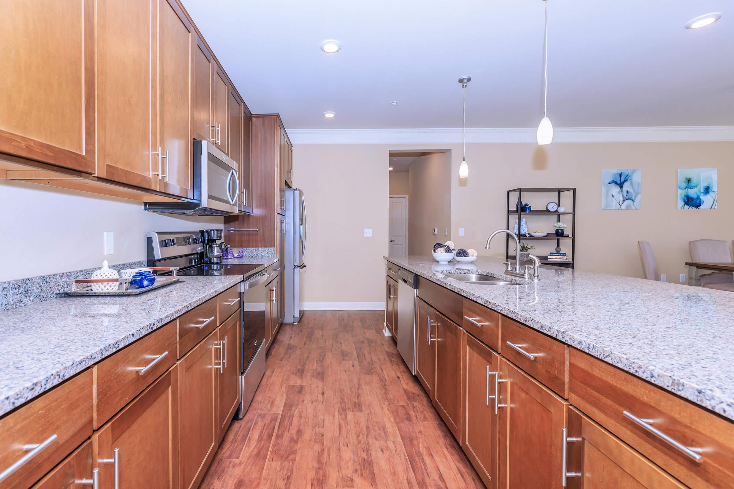 a modern kitchen with stainless steel appliances and wooden cabinets