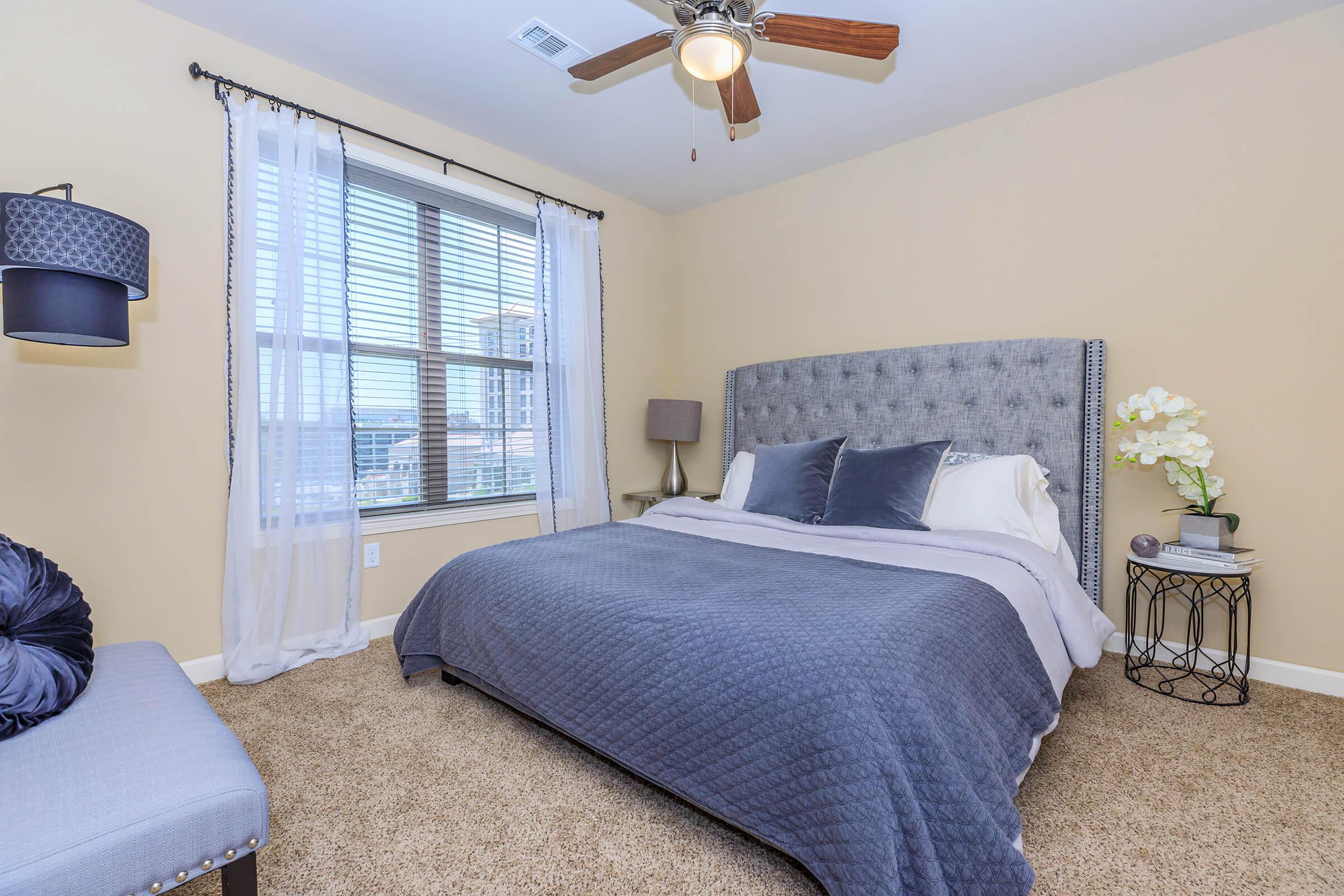 a bedroom with a bed and desk in a small room