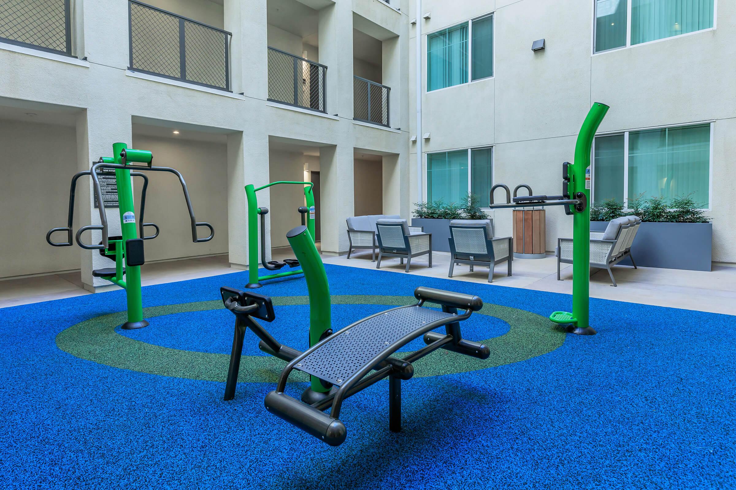 a blue and green chair in front of a building