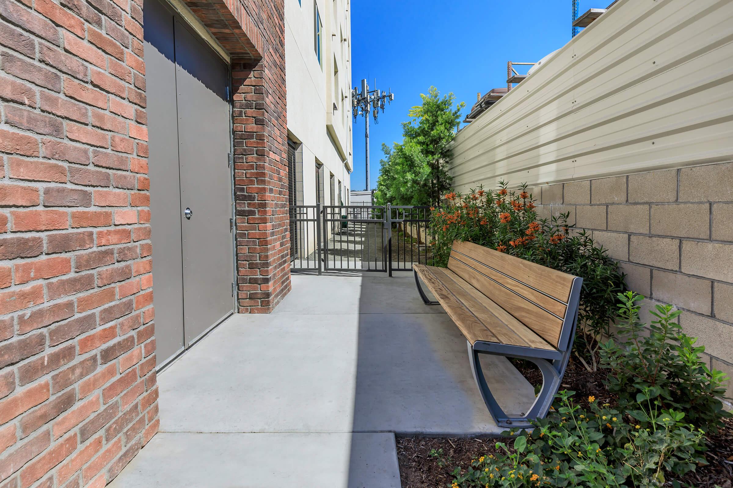 a bench in front of a brick building