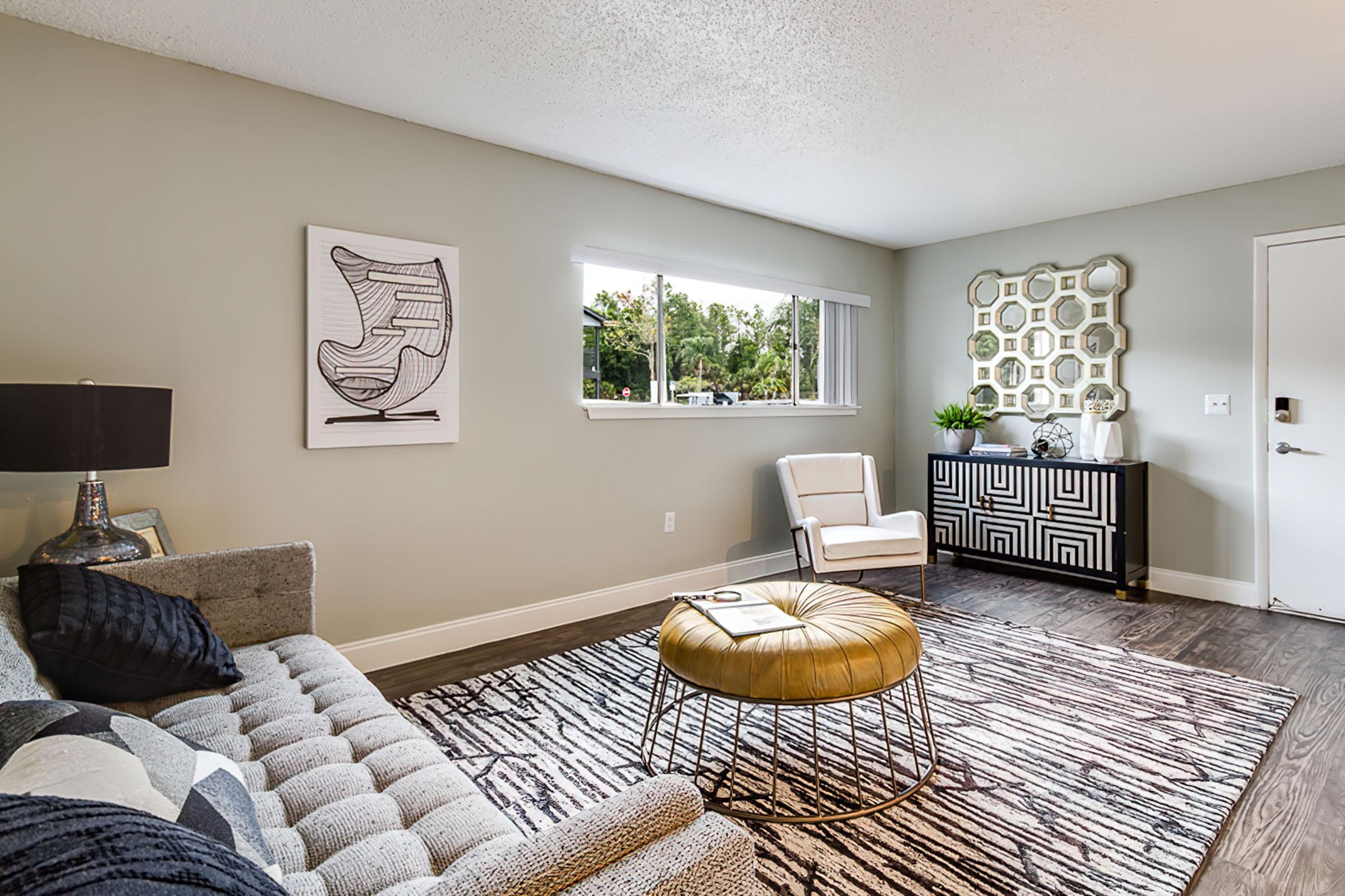 a living room filled with furniture and a large window