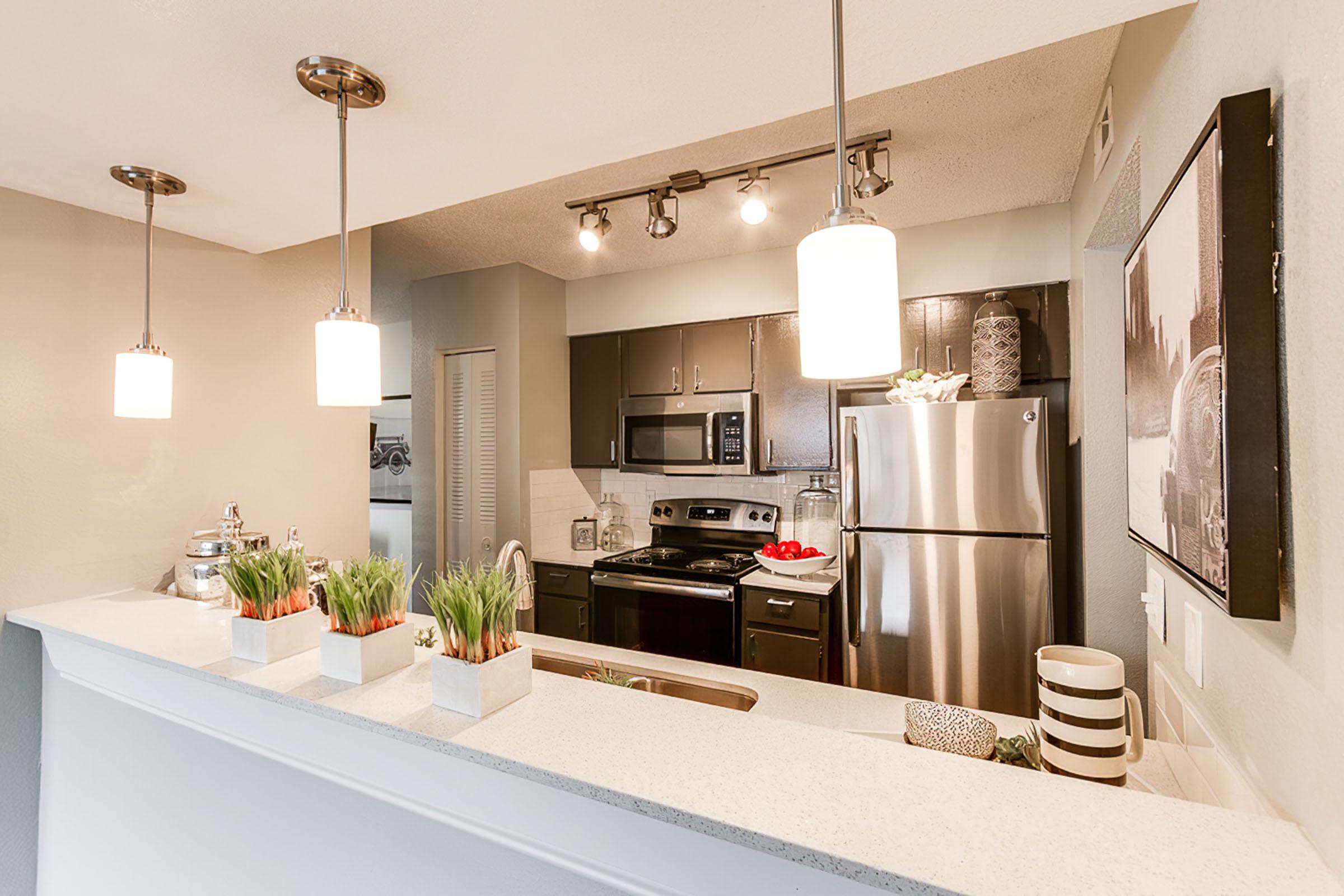 a kitchen with a sink and a mirror