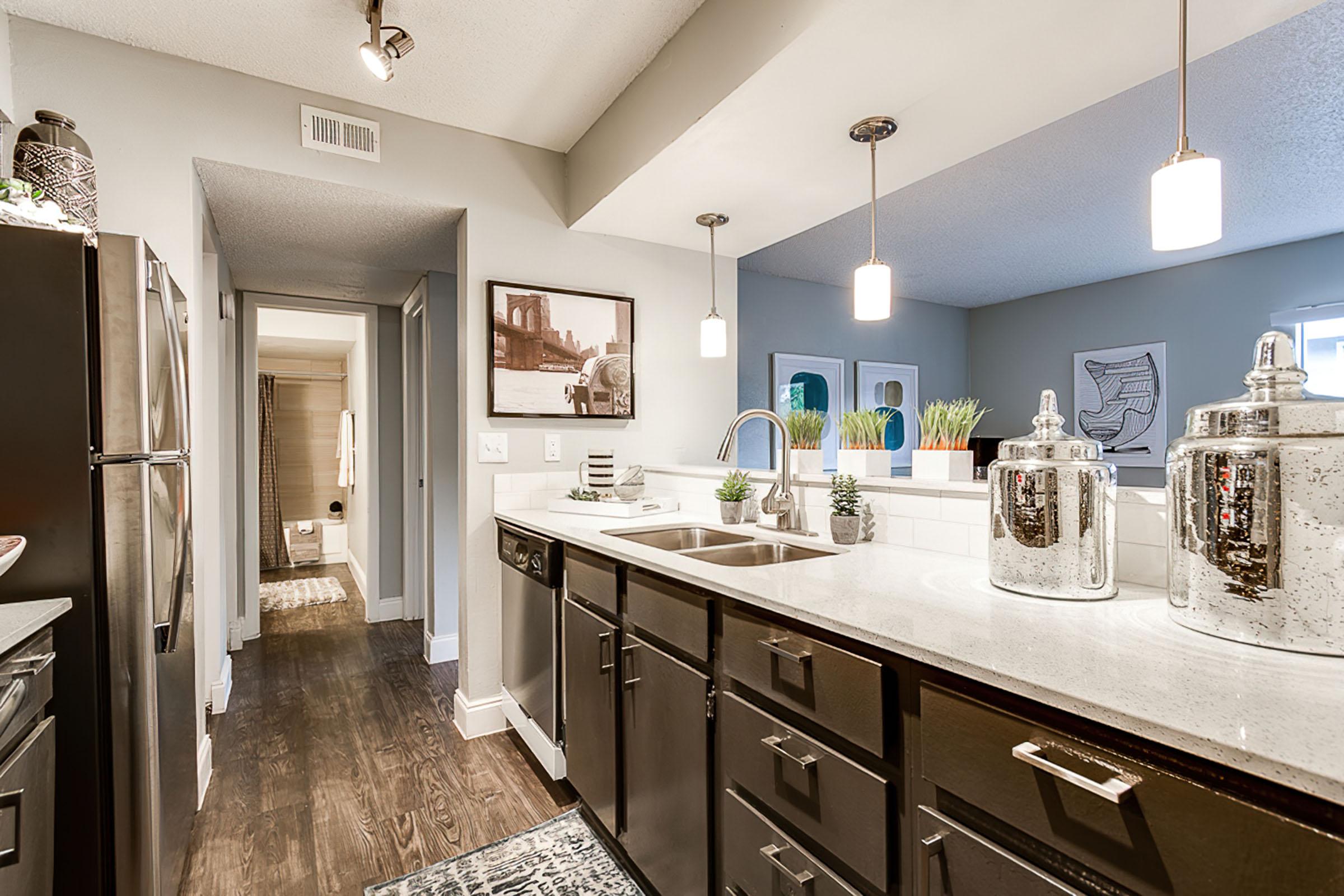 a kitchen with a sink and a mirror