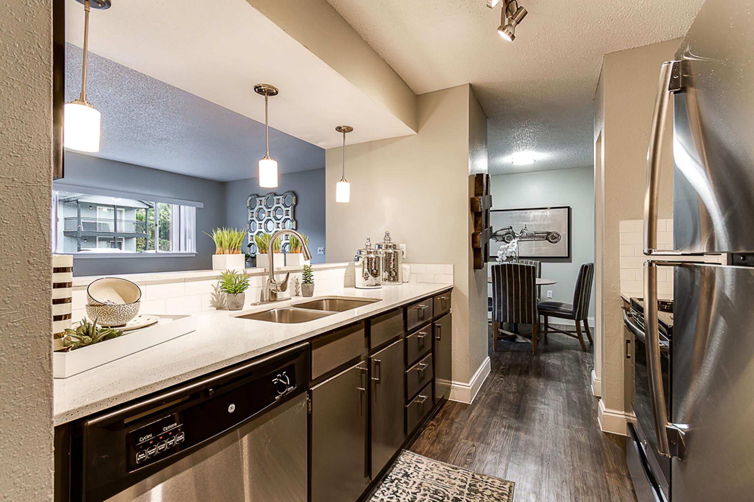 a kitchen with a sink and a mirror