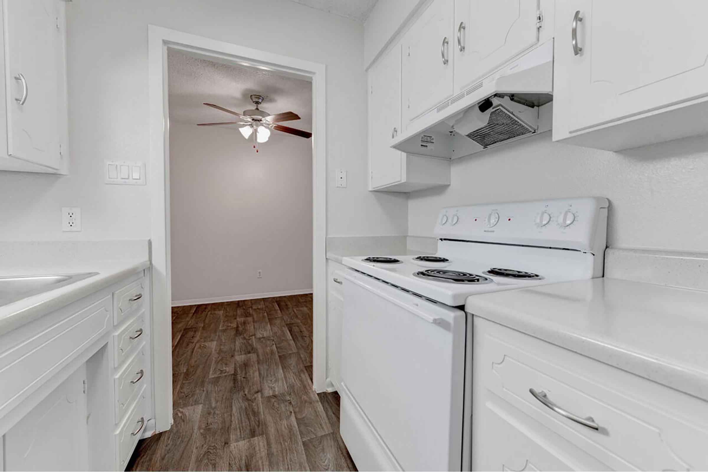 a kitchen with a sink and a refrigerator