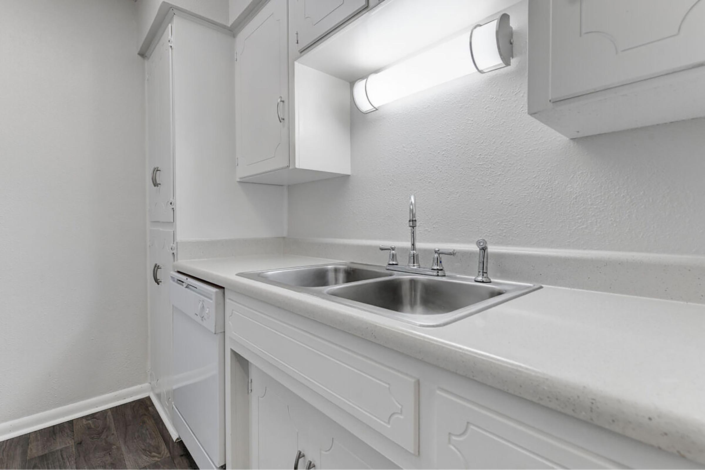 a kitchen with a sink and a mirror