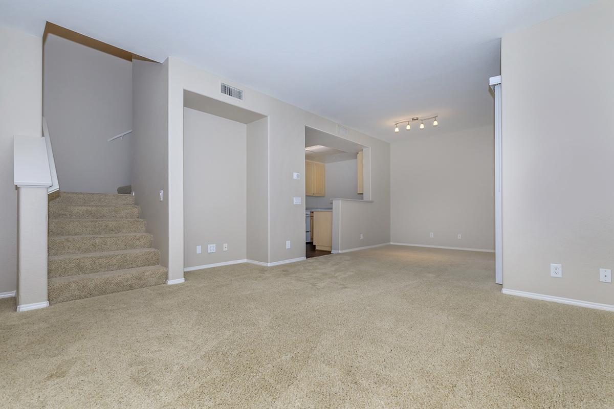Living room with carpeted stairs