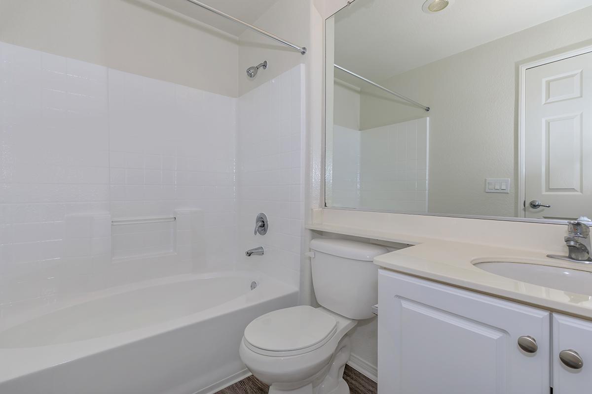 Vacant bathroom with white cabinets