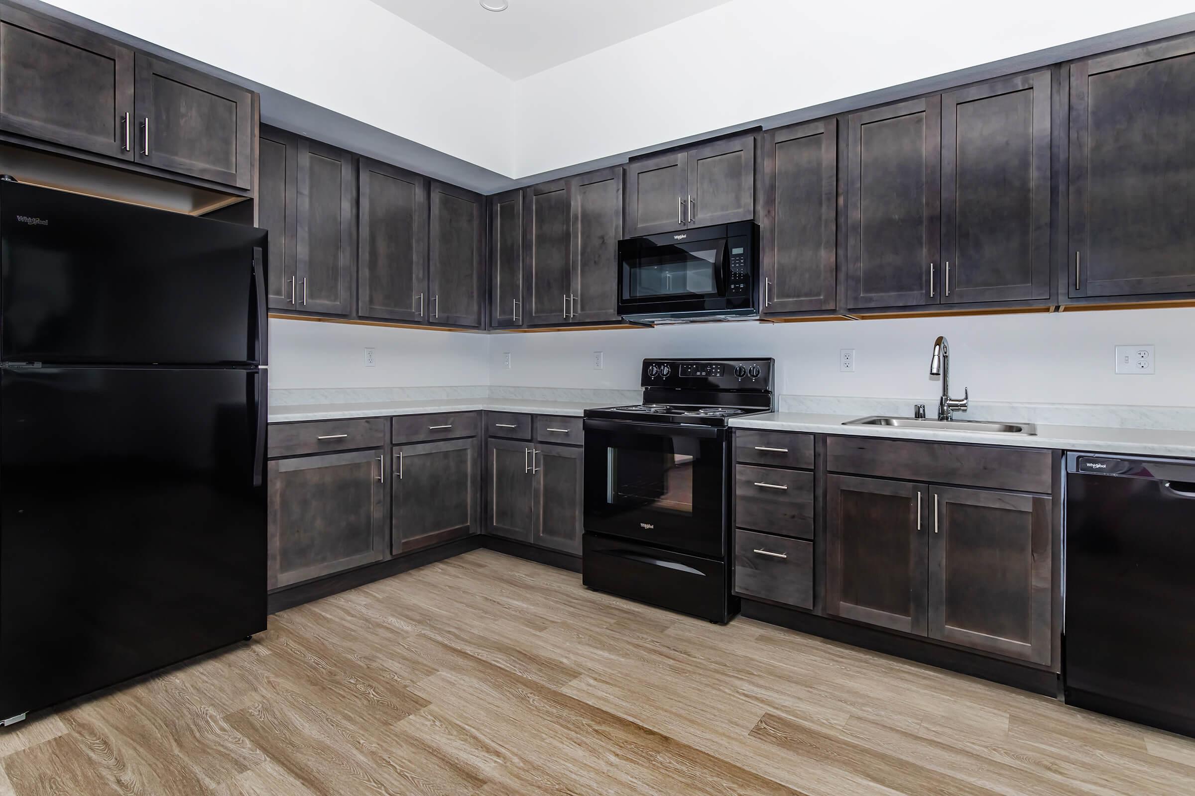 a modern kitchen with stainless steel appliances and wooden cabinets