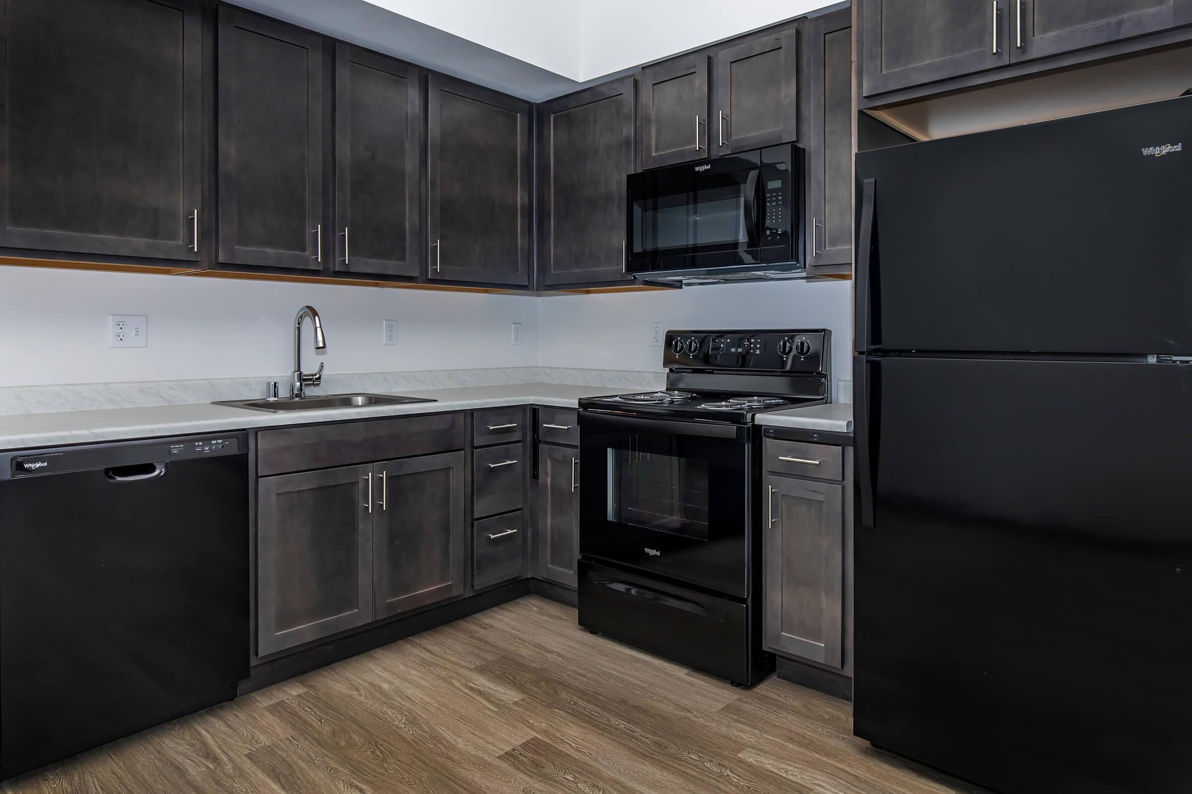 a kitchen with stainless steel appliances and wooden cabinets