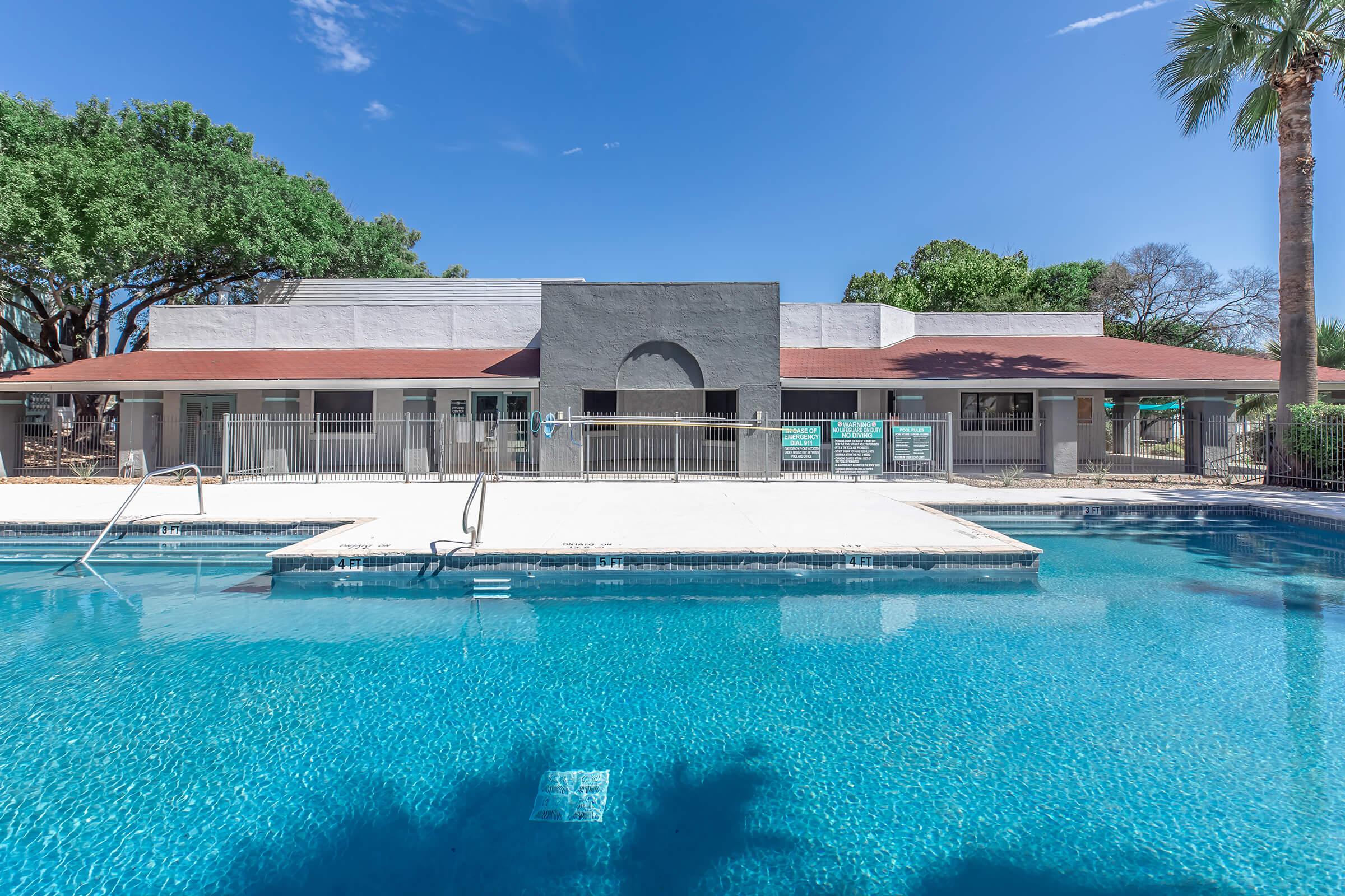 a large pool of water in front of a house