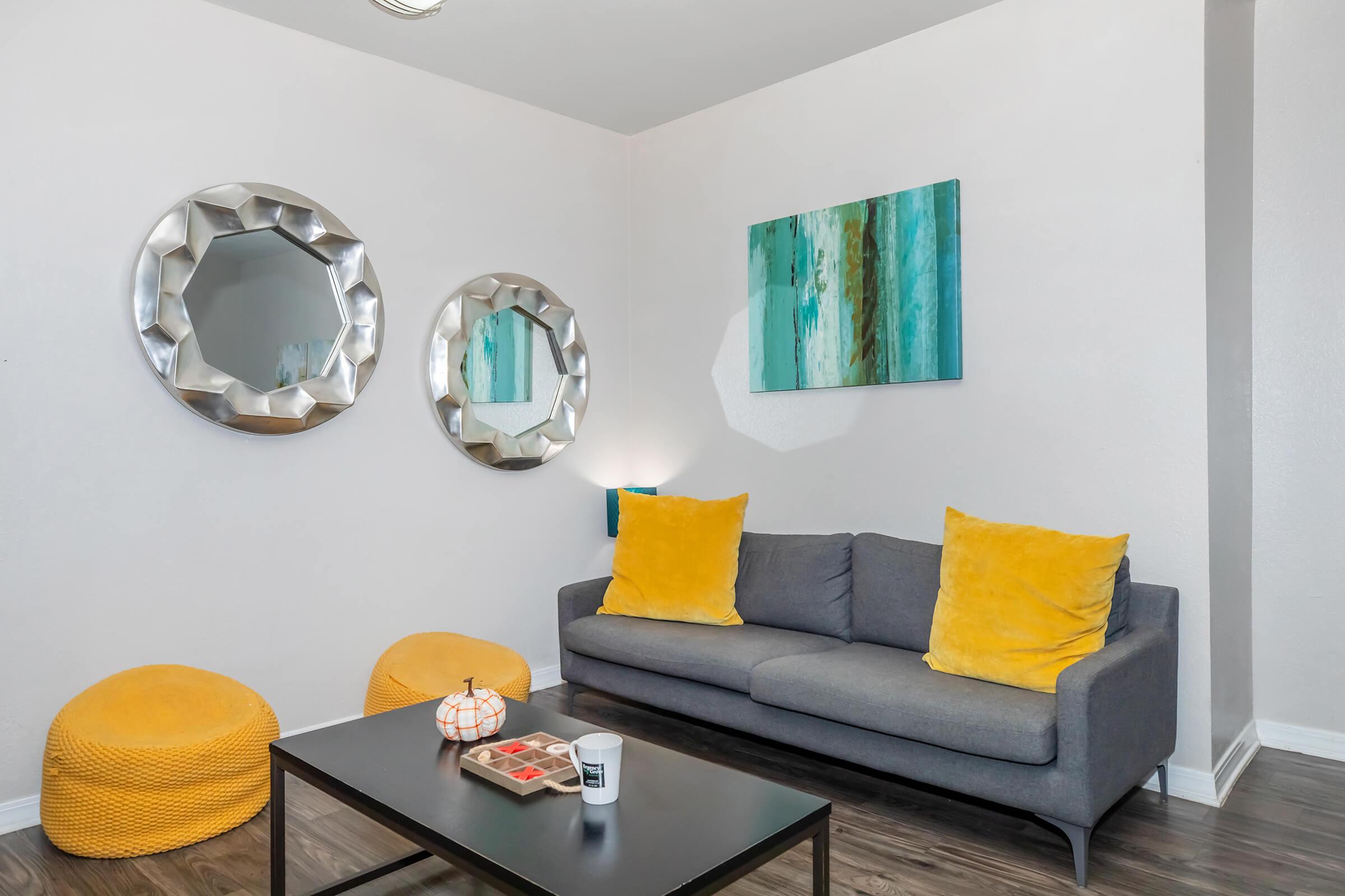 a living room filled with furniture and vase on a table