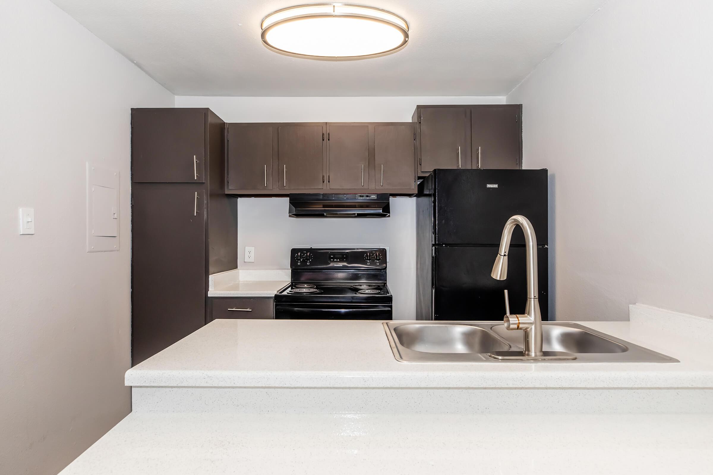 a kitchen with a sink and a mirror