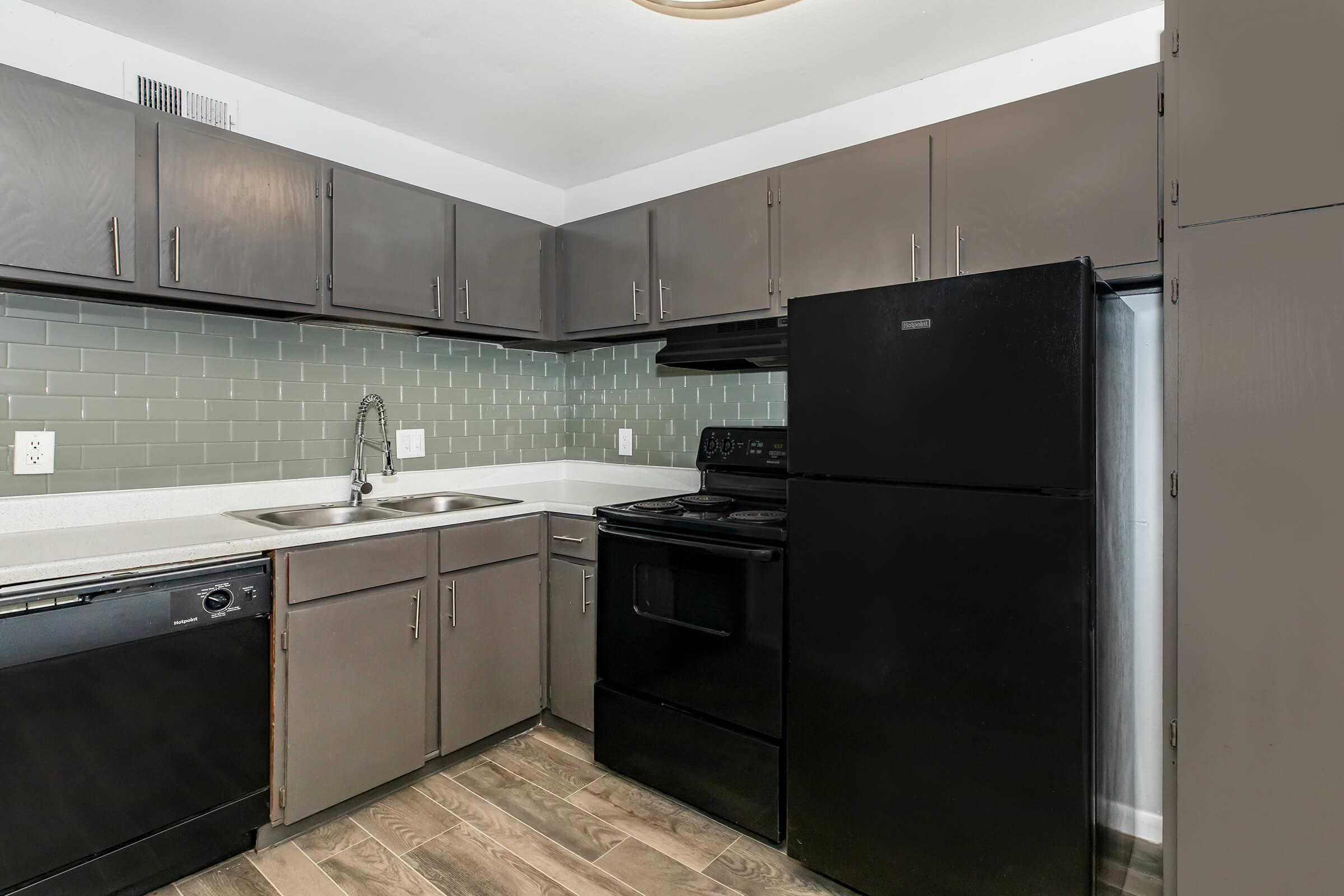 a kitchen with a stove and a refrigerator