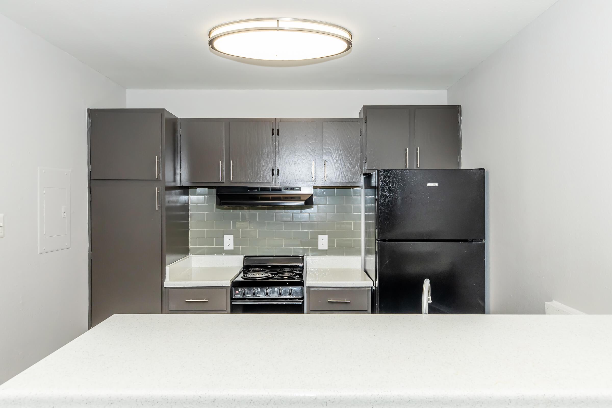 a kitchen with a stove and a refrigerator